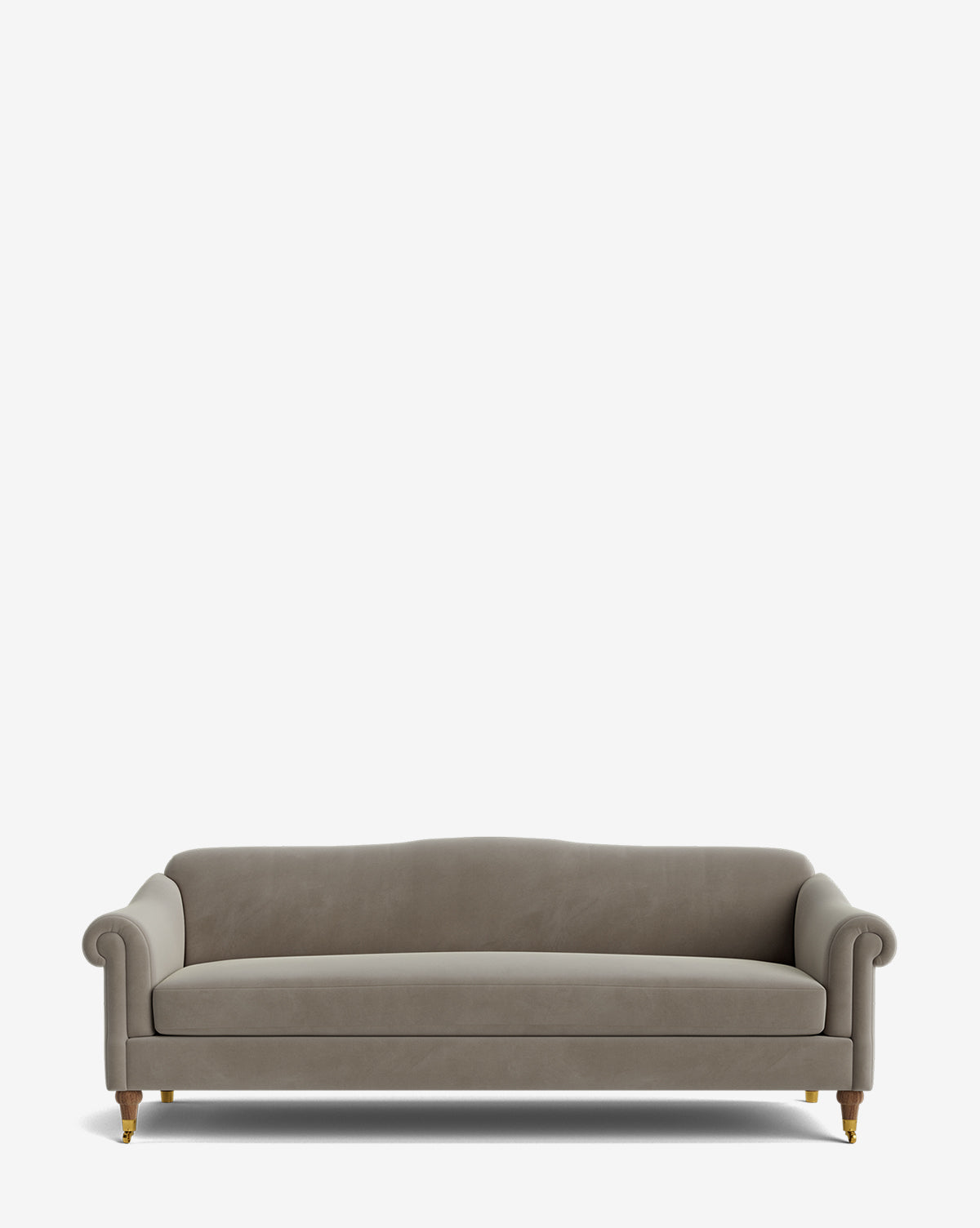 The Hildegard Sofa 90 is a grey upholstered, handcrafted sofa with rounded arms, a subtly curved backrest, and wooden legs featuring brass casters, shown against a plain white background by McGee & Co.
