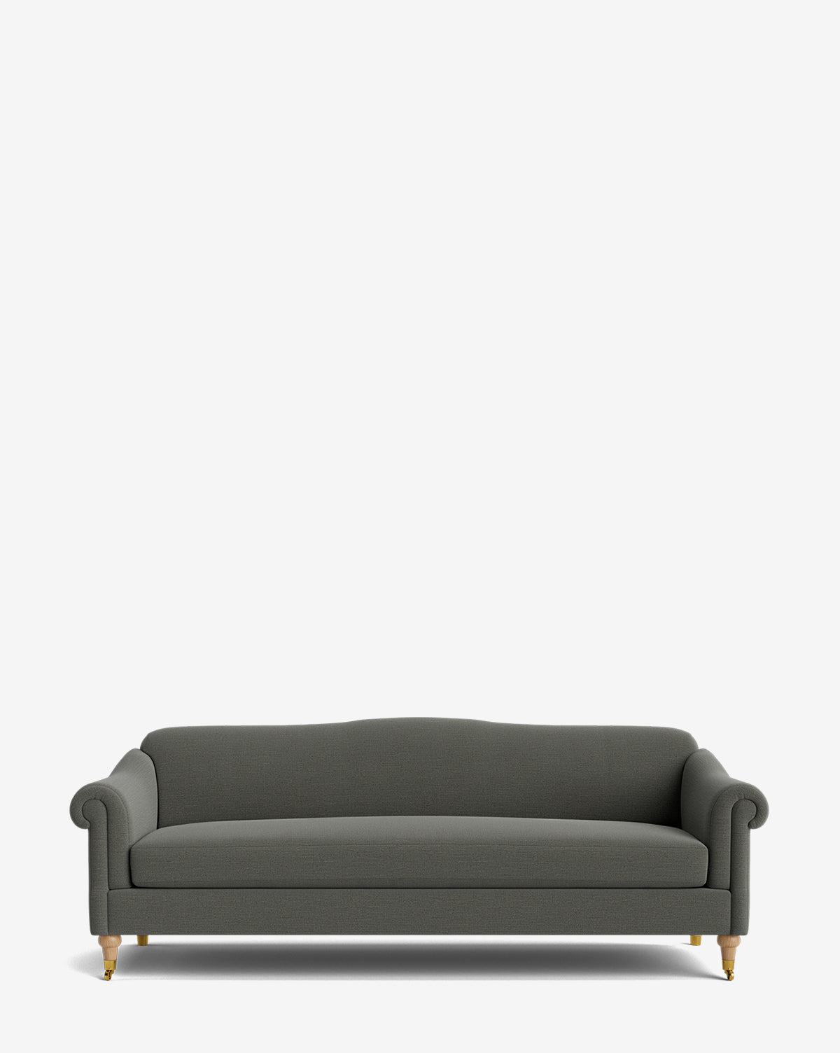 The Hildegard Sofa 90 is a dark gray, handcrafted sofa with rolled arms and wooden legs on brass casters, displayed against a plain white background, by McGee & Co.