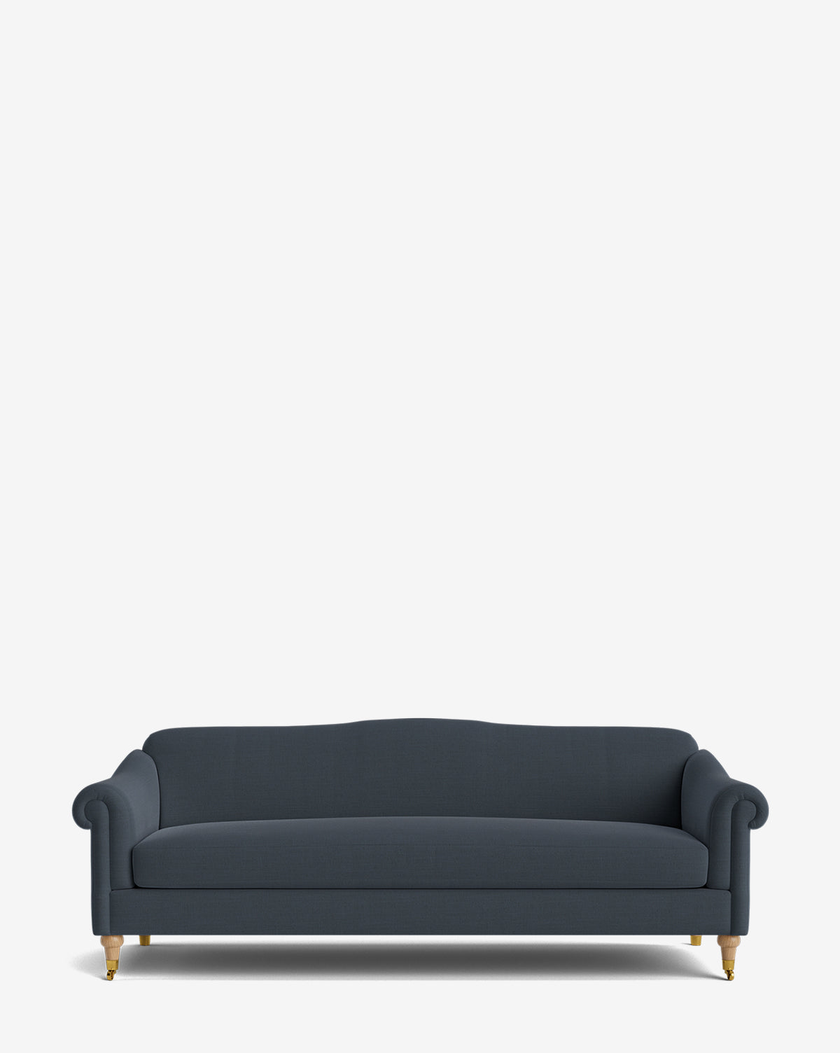 The Hildegard Sofa 90 is a dark blue, handcrafted sofa featuring rolled arms, a slightly curved backrest, and wooden legs with brass casters, shown against a plain white background by McGee & Co.