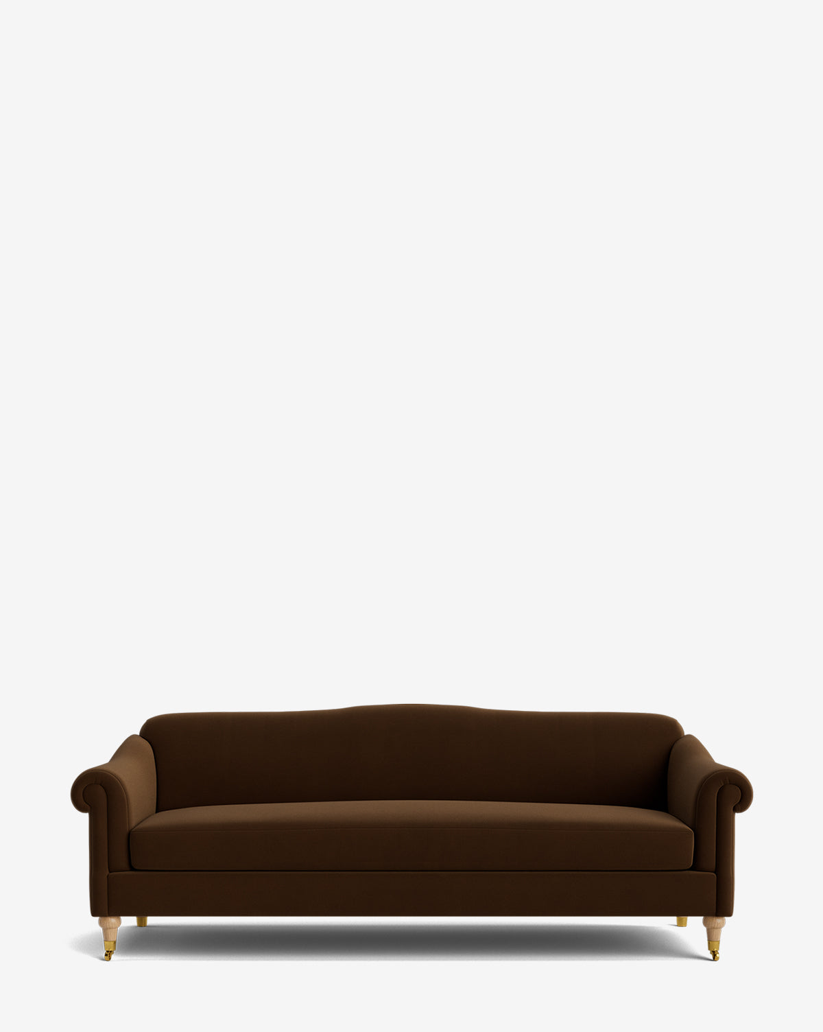 The Hildegard Sofa 90 is a dark brown, handcrafted upholstered sofa featuring rolled arms, a curved backrest, and short wooden legs with gold-colored feet, shown against a plain white background by McGee & Co.