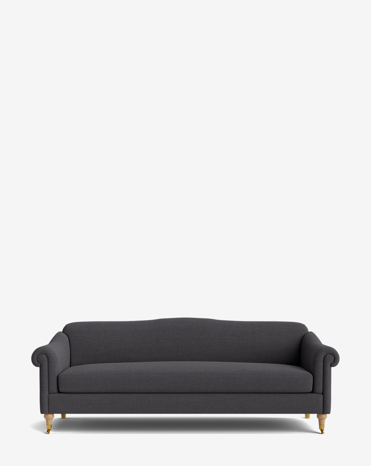 The Hildegard Sofa 90 is a dark gray upholstered, handcrafted sofa featuring rolled arms and wooden legs with brass casters, shown against a plain white background by McGee & Co.