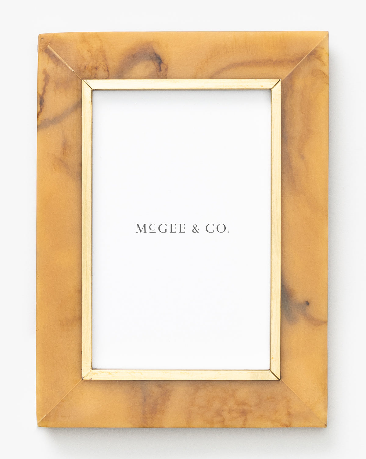 The Horn Design Frame features a rectangular shape with a marbled tan and brown border, inner gold trim, and a white MCGEE & CO. placeholder—an elegant accent for any home decor.