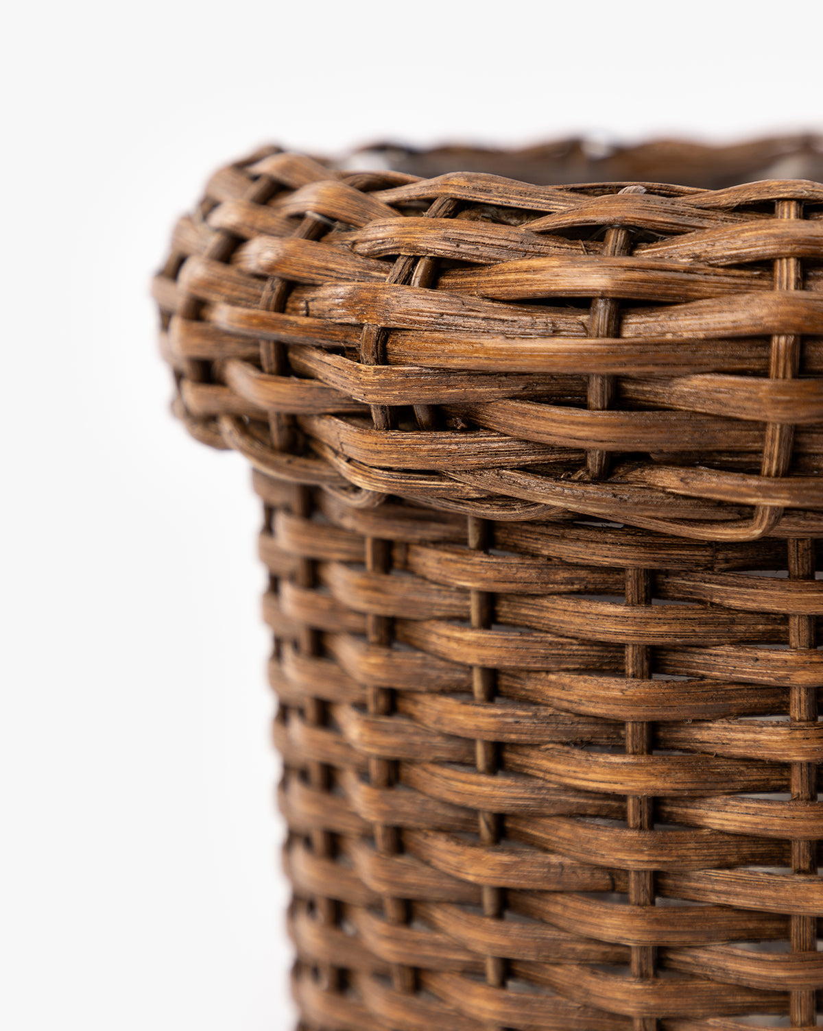 Close-up of the Huger Woven Planter's upper portion, showcasing its detailed texture and interlaced brown fibers against a white background, by McGee & Co.
