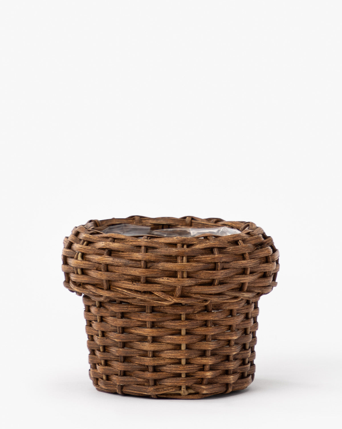 The Huger Woven Planter is a small, round, brown planter with a wide, flat rim and a clear plastic liner, shown against a plain white background, by McGee & Co.