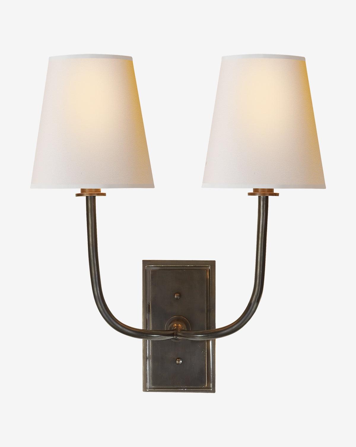 The Hulton Double Sconce by Visual Comfort & Co. Signature features two upward-curving brass arms with linen shades, offering a warm metallic glow beautifully contrasted against a clean white background, blending timeless elegance with the sophisticated touch of McGee & Co.