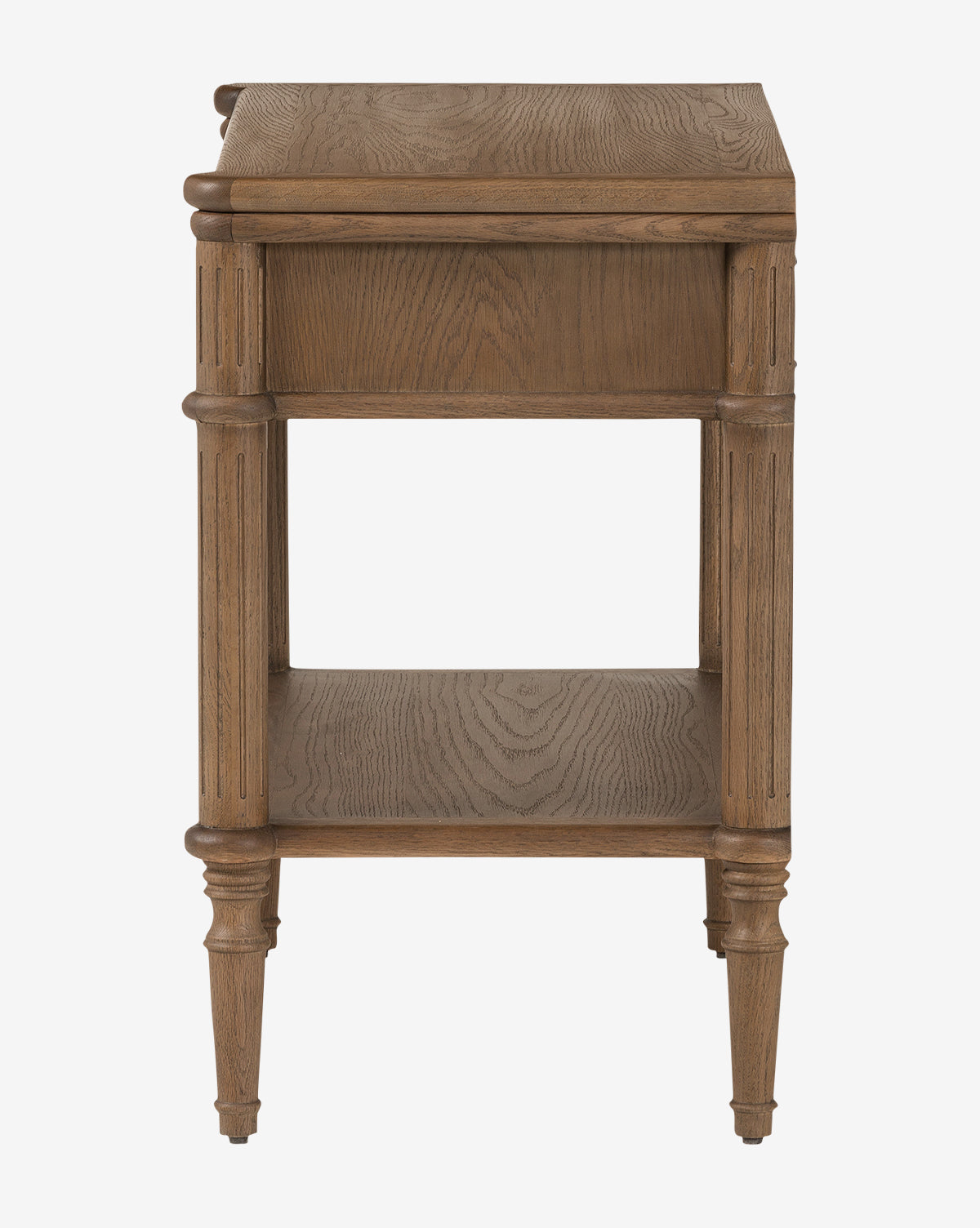 The Humphrey Nightstand is a wooden piece with fluted legs, a natural finish, one lower shelf, and a rectangular top featuring subtle carved edges—an elegant traditional design shown from the side by McGee & Co.