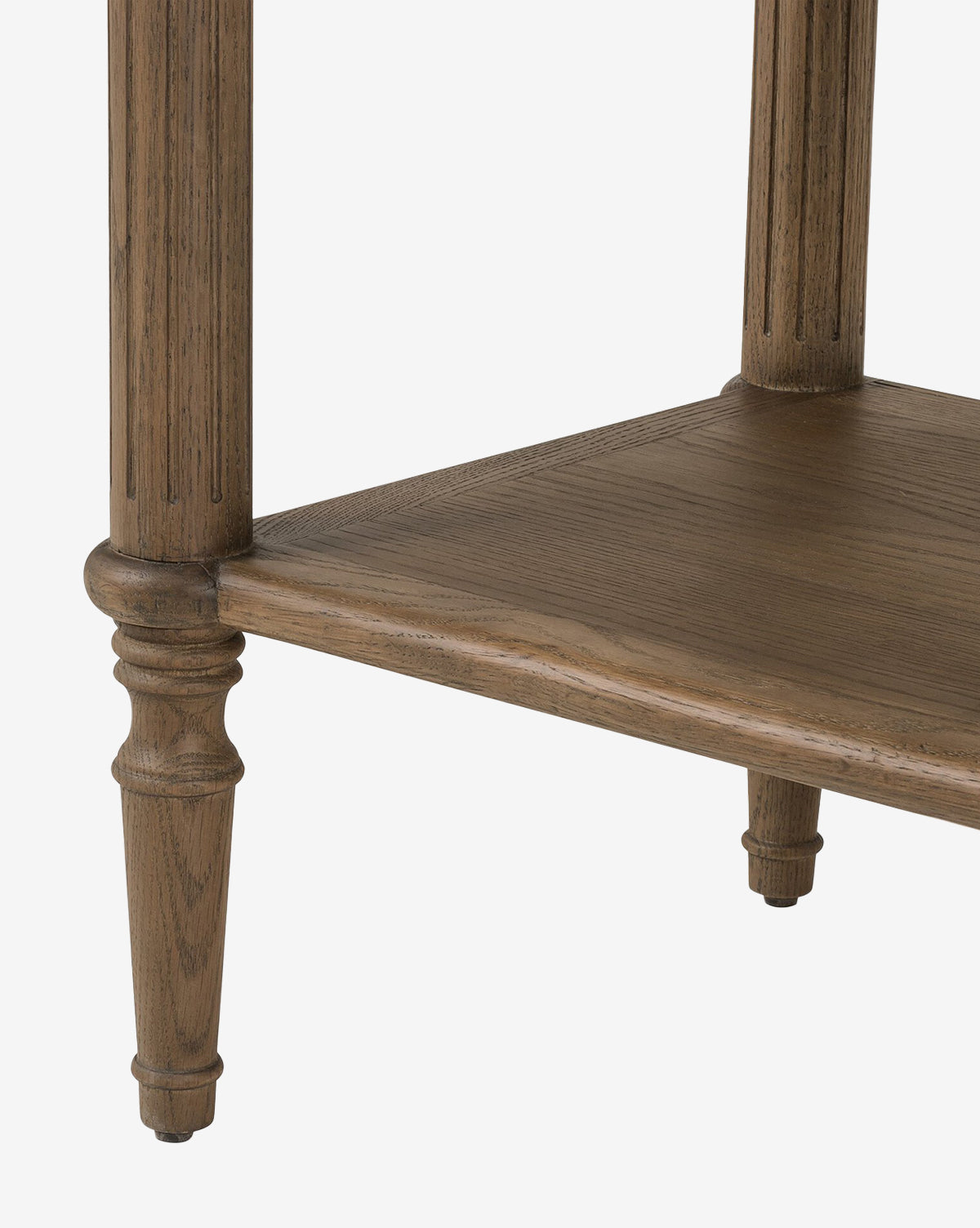 Close-up of the Humphrey Nightstand’s lower section, featuring two carved legs and a flat bottom shelf with natural wood grain—a stylish choice for traditional bedroom décor, by McGee & Co.