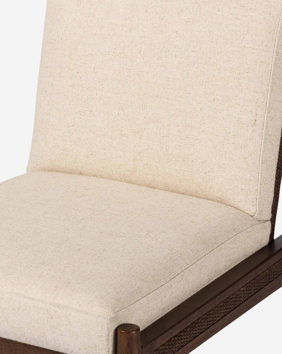 Close-up of the Hurley Dining Chair, showcasing performance upholstery, a cushioned beige seat, dark wooden frame, and sleek modern lines, by McGee & Co.