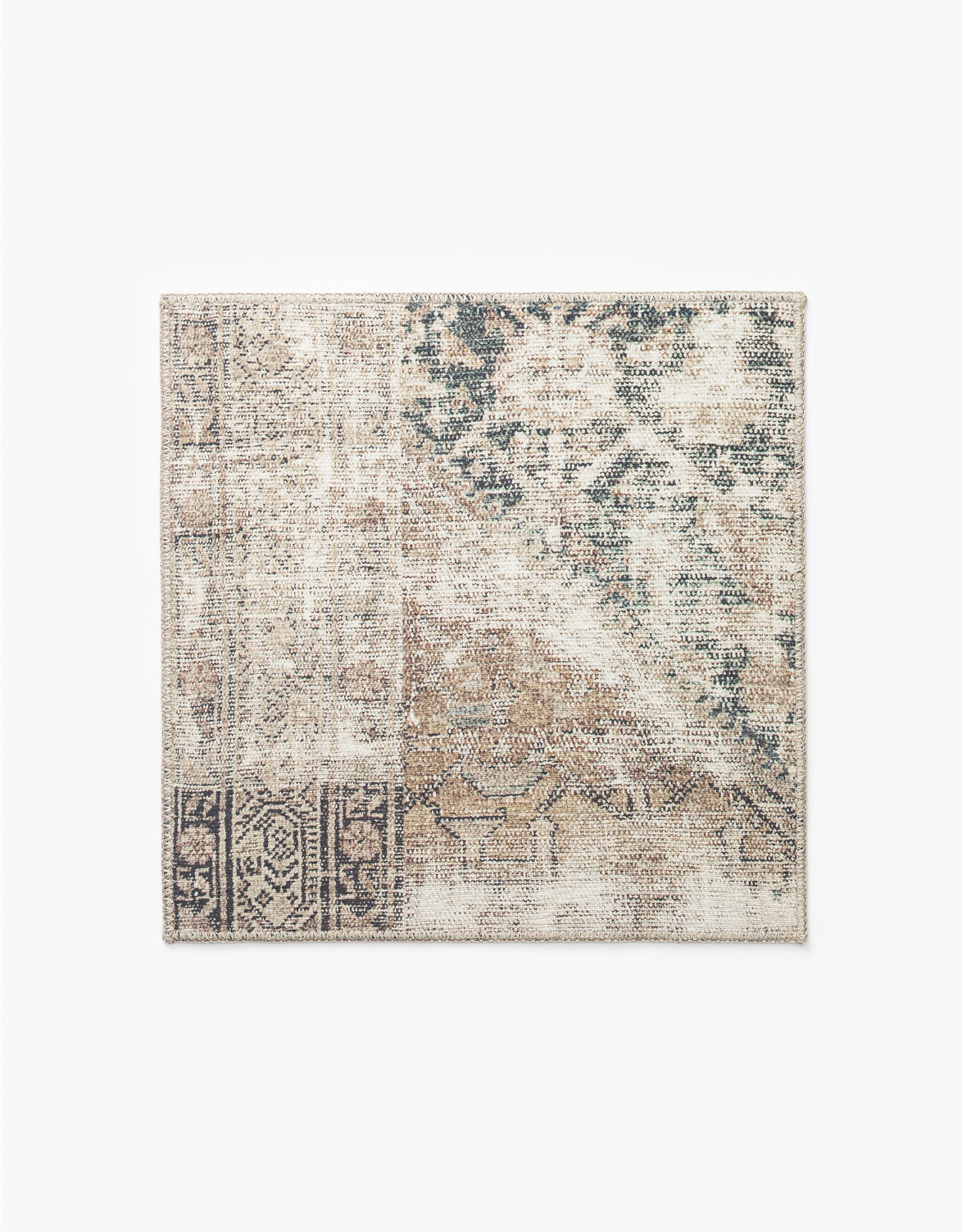 The Idalia Rug Swatch features a rectangular shape and a distressed patchwork design in beige, brown, black, and green with intricate patterns and faded traditional motifs, making it an ideal neutral palette rug for any room, by McGee & Co.