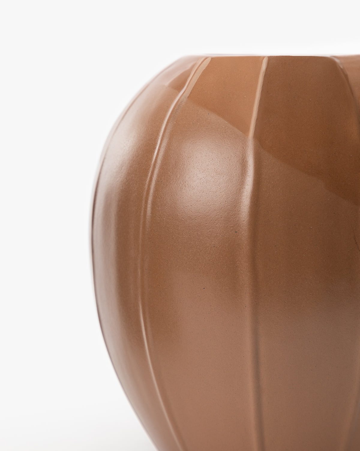 Close-up of the Idris Vase, a smooth, rounded brown stoneware piece featuring vertical indented lines, displayed against a plain white background.