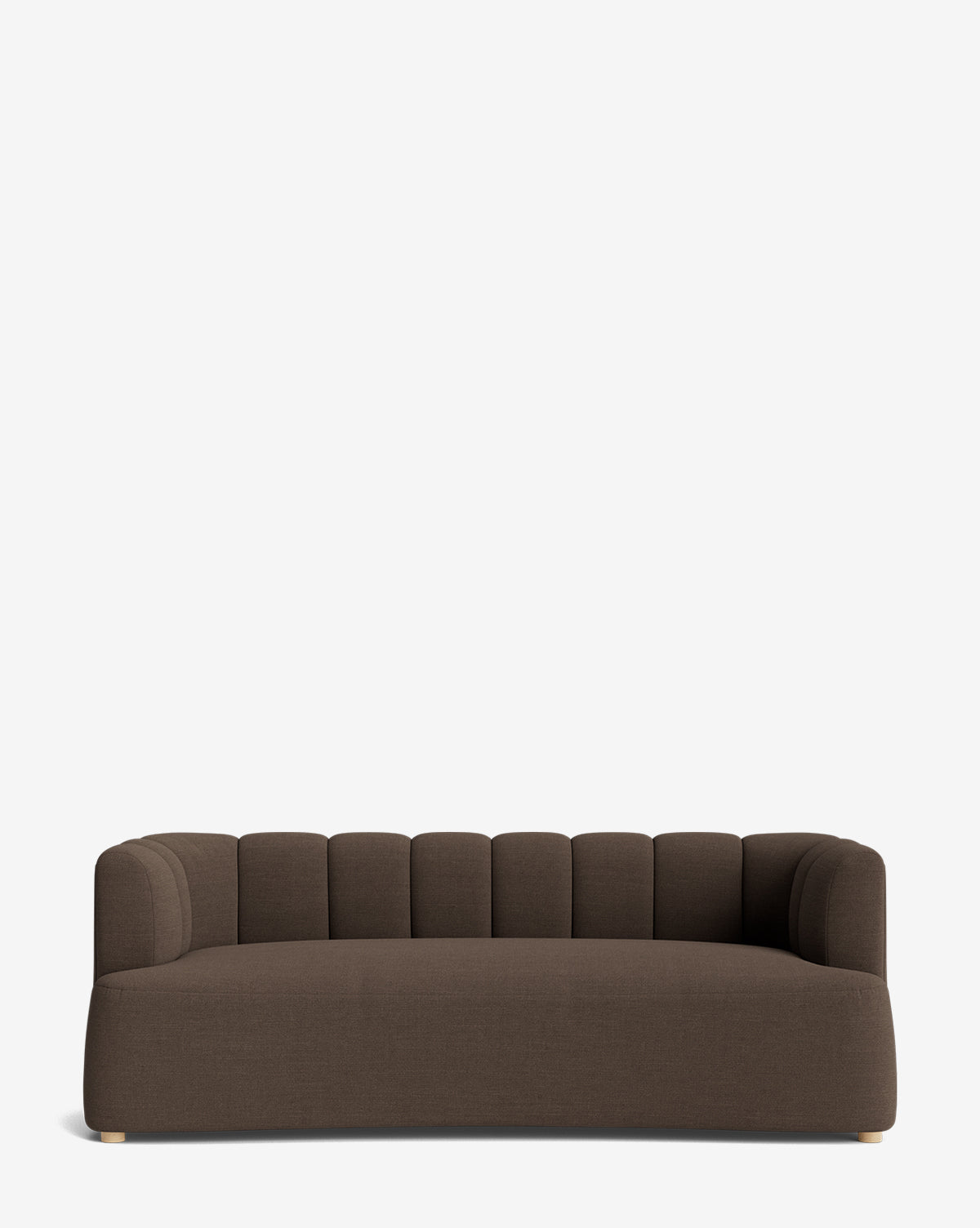 The Ines Sofa 90 is a modern dark brown velvet sofa with a low back, curved arms, and vertical channel tufting on the backrest. It features short, light-toned feet and a sleek silhouette, shown against a plain white background by McGee & Co.