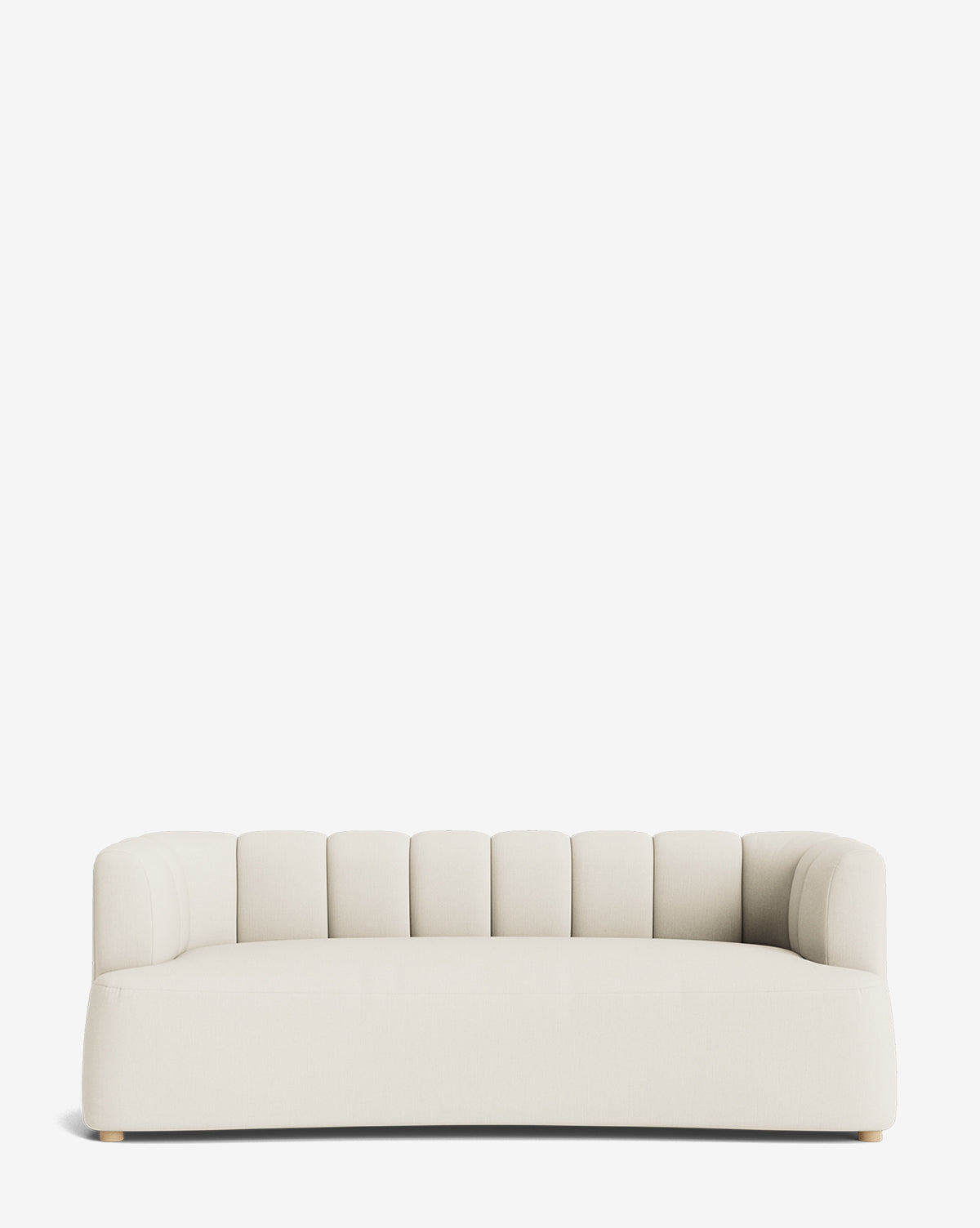 A modern, low-profile Ines Sofa 90 in cream with a curved backrest and vertical channel tufting, set against a plain white background by McGee & Co.