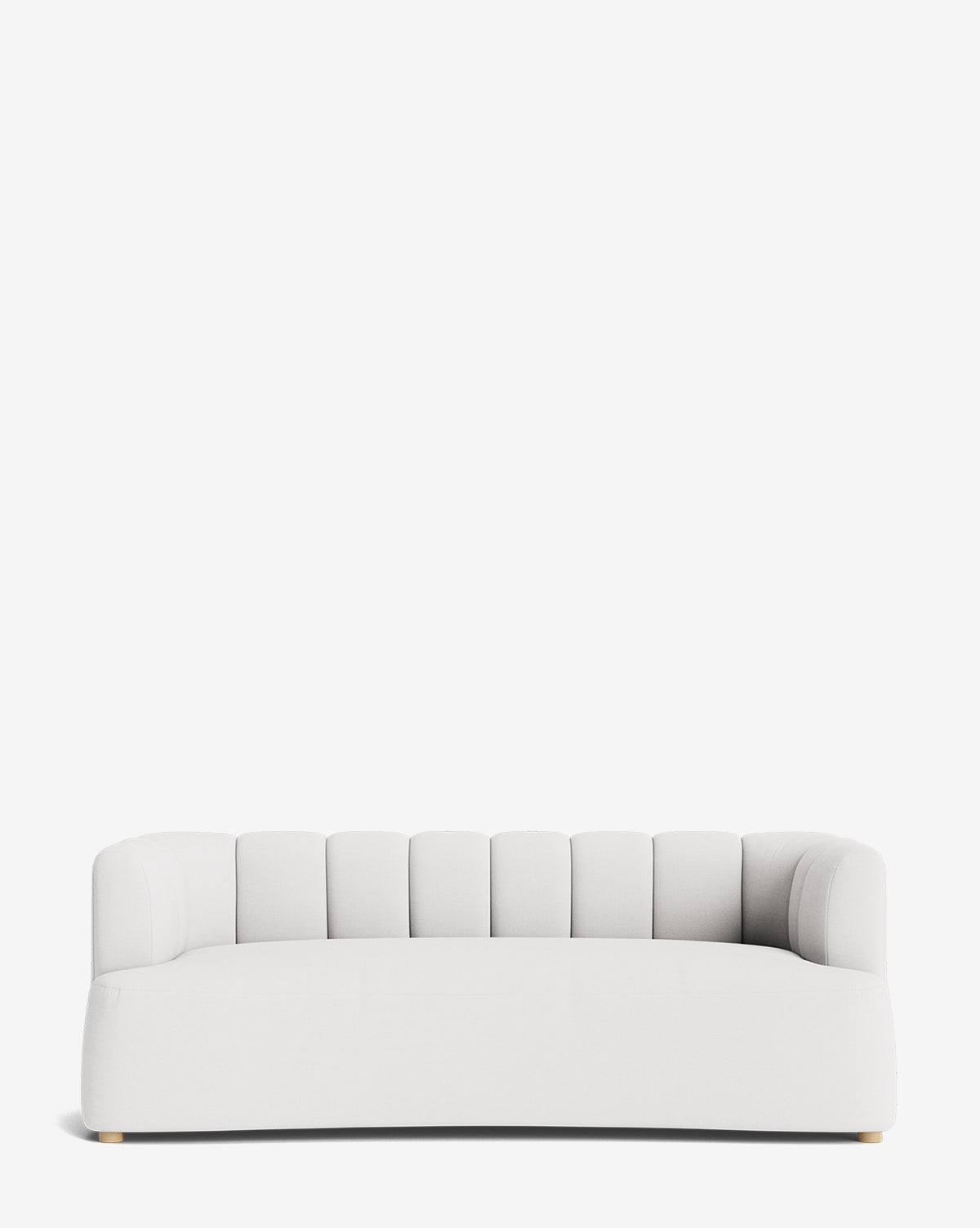 The Ines Sofa 90 is a modern sofa with a rounded backrest featuring vertical channel tufting, low arms, and short light-colored wooden legs, shown against a plain white background by McGee & Co.