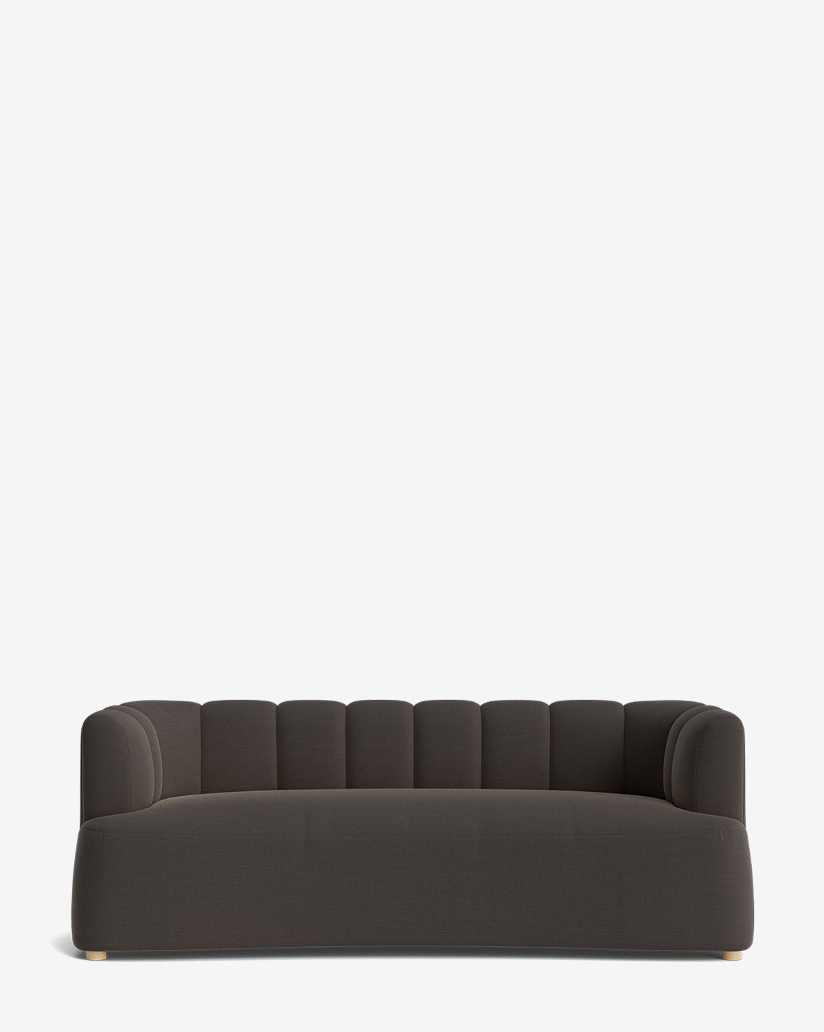 The Ines Sofa 90 is a modern dark gray velvet sofa with a low, rounded backrest, vertical tufted details, and gold-tone feet, shown on a plain white background by McGee & Co.