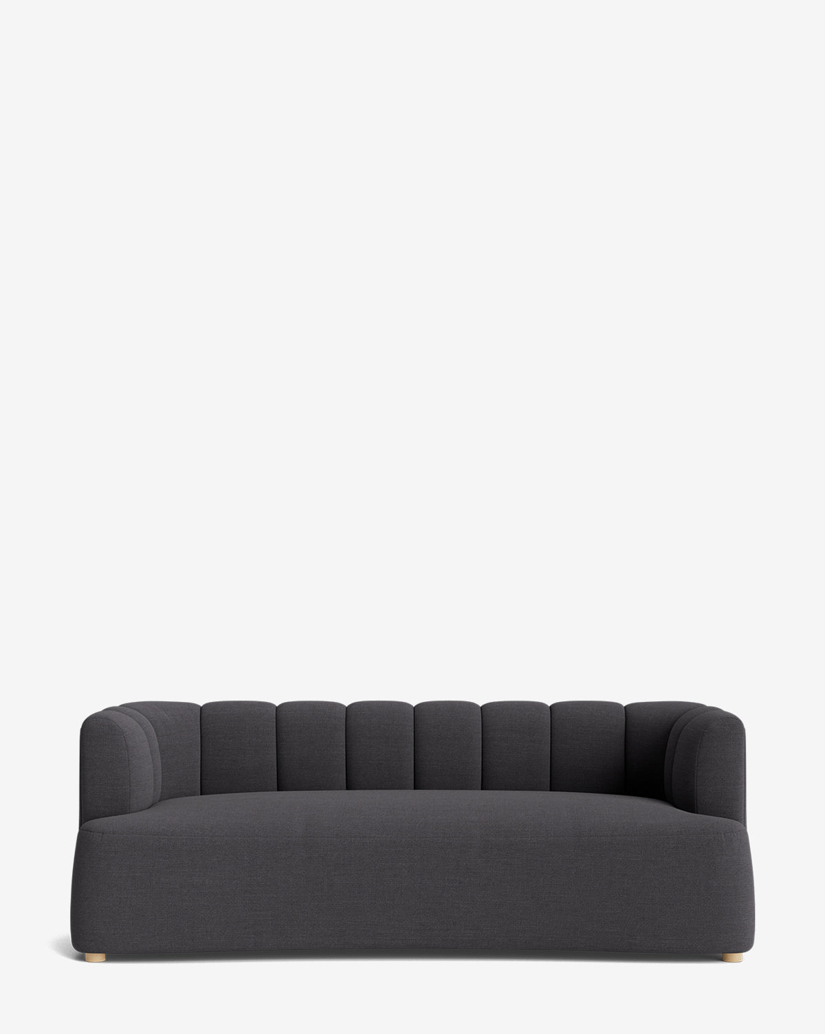 The Ines Sofa 90 features modern dark gray upholstery, a low back, vertically-stitched rounded cushions, wide seat, short light feet, and a sleek silhouette set against a plain white background by McGee & Co.