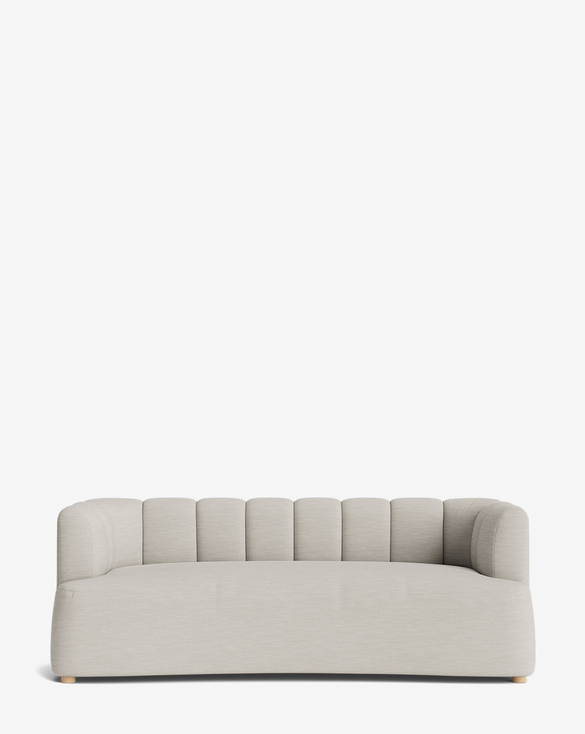 The Ines Sofa 90 is a modern, light gray velvet sofa with a low back and sides, vertical channel tufting, rounded edges, and small discreet wooden feet, set against a plain white background by McGee & Co.