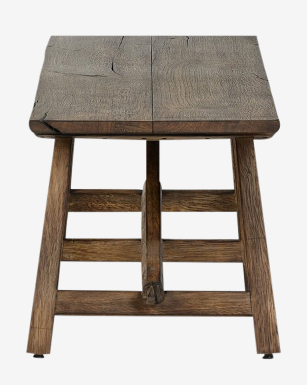 The Inka Bench is a rustic, artisanal piece with a wide rectangular seat and sturdy angled legs, crafted from burnt bleached oak to showcase natural grain and cracks—highlighting expert craftsmanship, by McGee & Co.