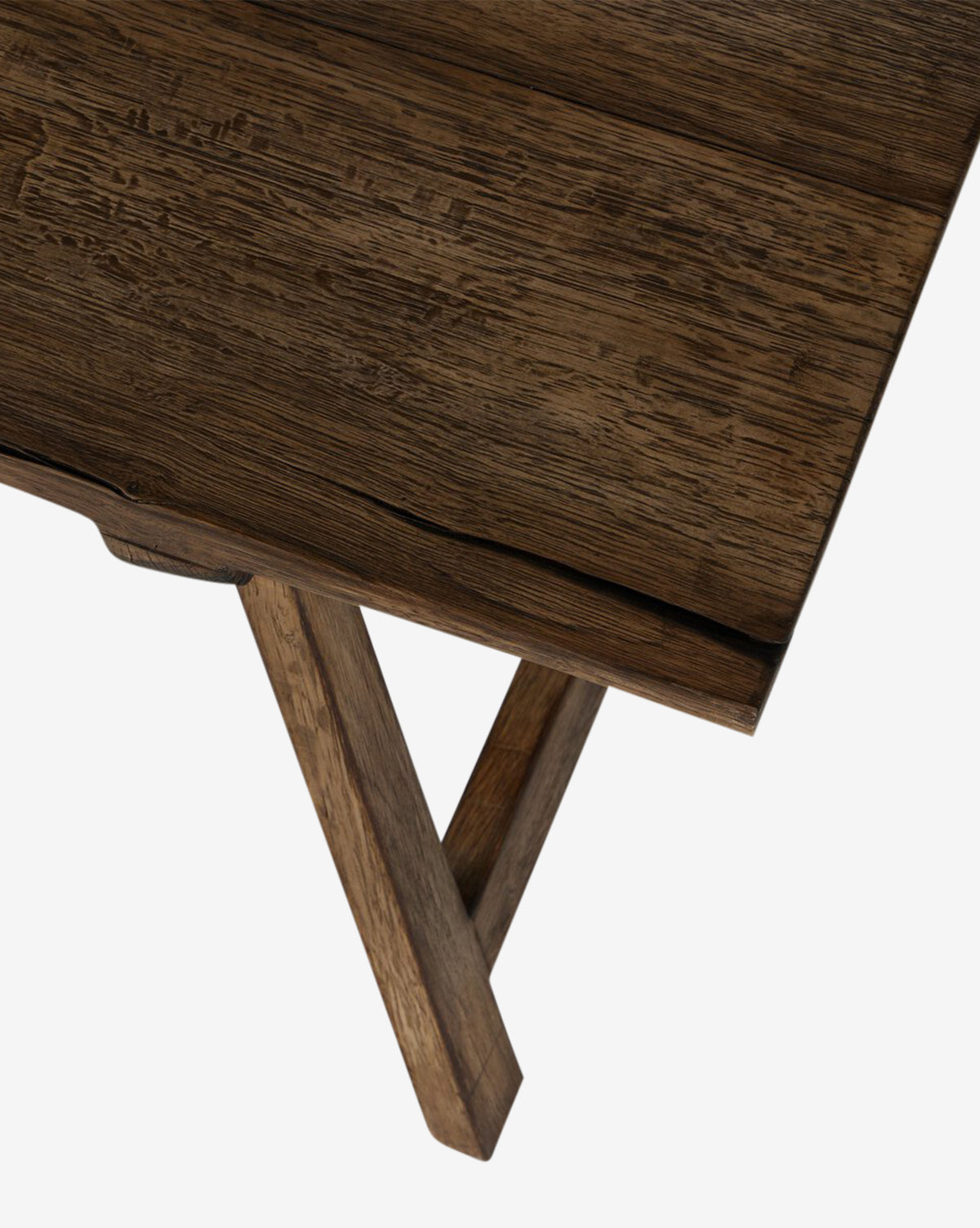 A close-up of the Inka Bench corner highlights its artisanal craftsmanship, featuring rustic burnt bleached oak grain and angled legs, set against a white background by McGee & Co.