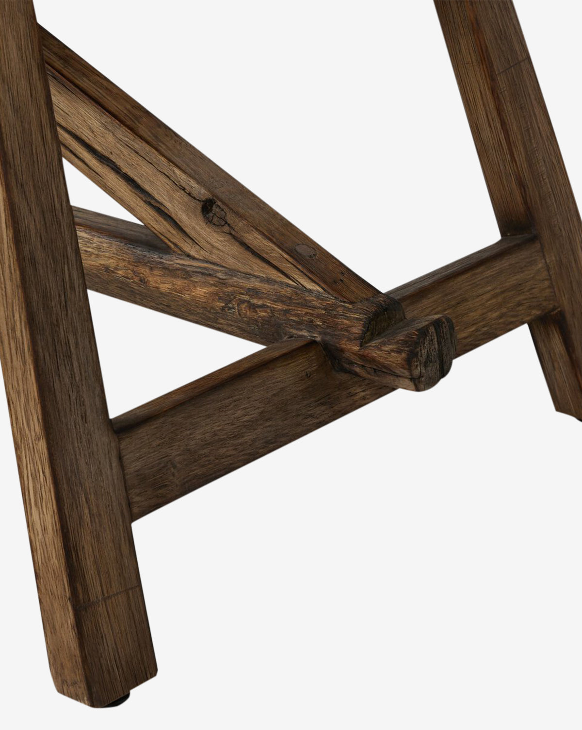 Close-up of the Inka Bench’s wooden base and legs in burnt bleached oak, highlighting intricate wood grain and intersecting beams that display artisanal craftsmanship against a white background, by McGee & Co.