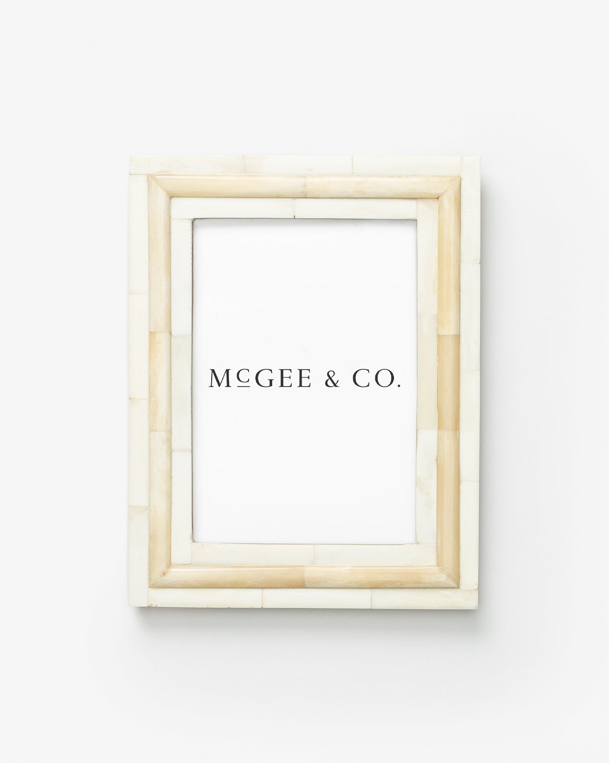 The Inlay Bone Frame is a rectangular photo frame featuring a beige and cream tiled border with elegant bone trim, shown against a plain white background with an insert labeled McGEE & CO.