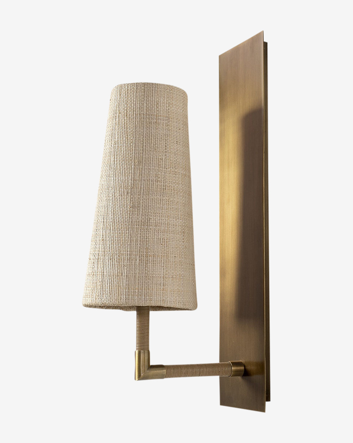 The Irving Sconce pairs a rectangular brass backplate and refined arm with a textured raffia shade, creating a warm, sophisticated accent, by McGee & Co.