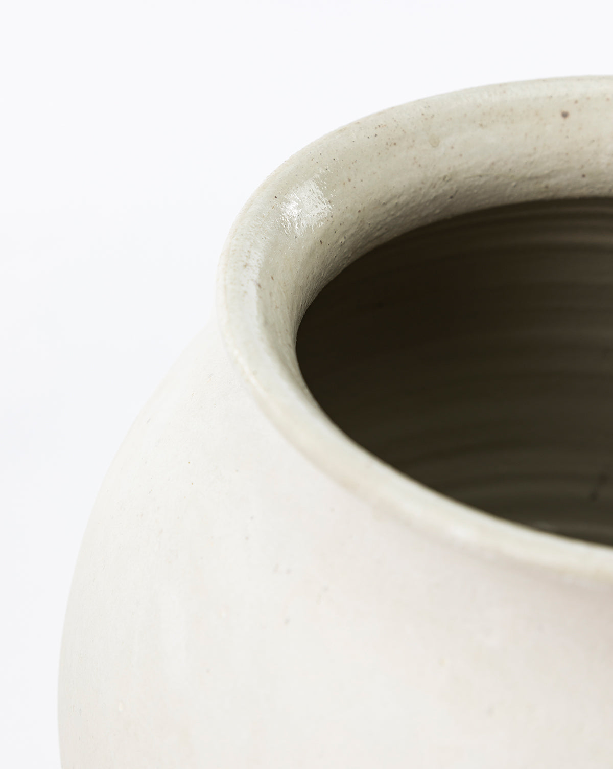 Close-up of the Isla Terracotta Vase’s rim and upper side features its smooth, slightly glossy finish and subtle organic texture against a plain white background—an ideal accent to elevate your home decor, by McGee & Co.