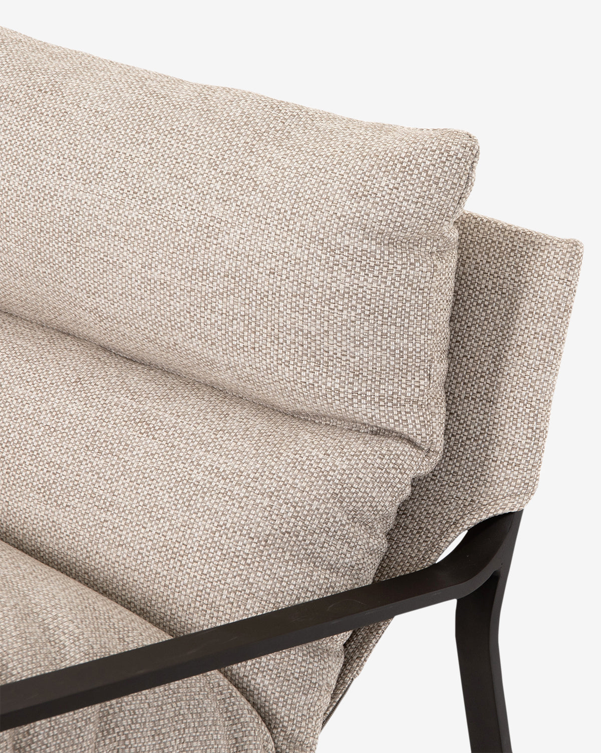 Close-up of the Ismay Sling Chair featuring a sleek black frame, modern design, and a textured beige removable cushion, highlighting the armrest and backrest against a plain white background, by McGee & Co.