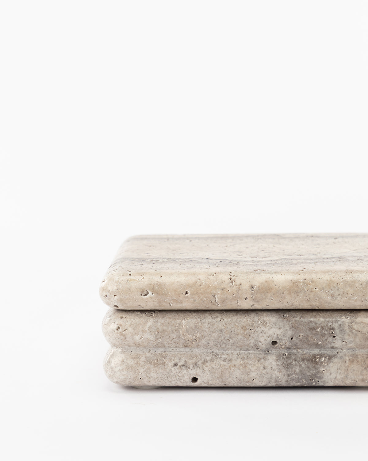 Close-up of two stacked Ives Stone Box slabs with rounded edges and a slightly textured beige surface, resembling an elegant decorative box, set against a plain white background.