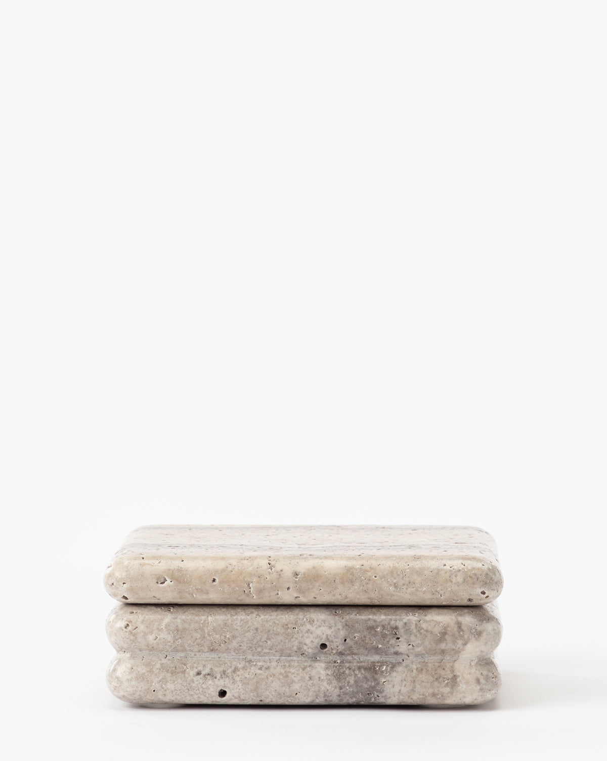 The Ives Stone Box is a small, rectangular beige container with rounded edges and natural textures, elegantly displayed against a plain white background.
