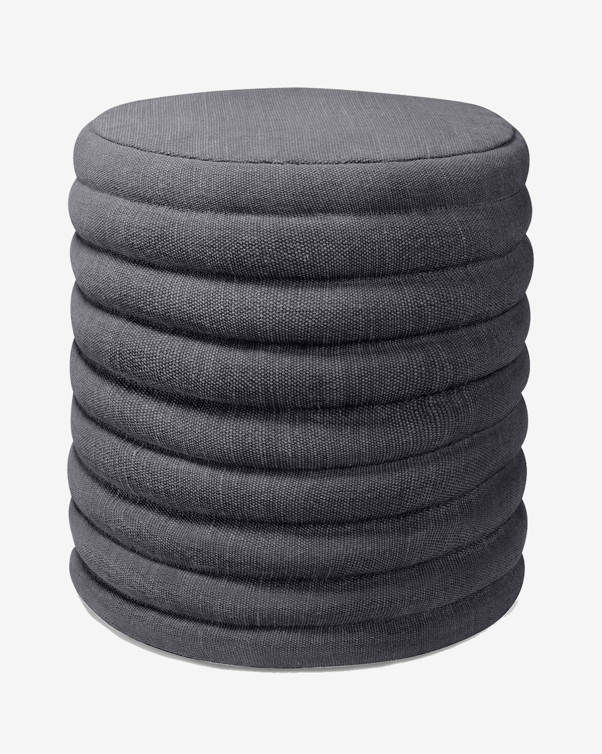 The Jefferson Stool by Made Goods is a round, dark gray fabric ottoman with a ribbed, layered design inspired by mid-century style, shown against a plain white background. McGee & Co.