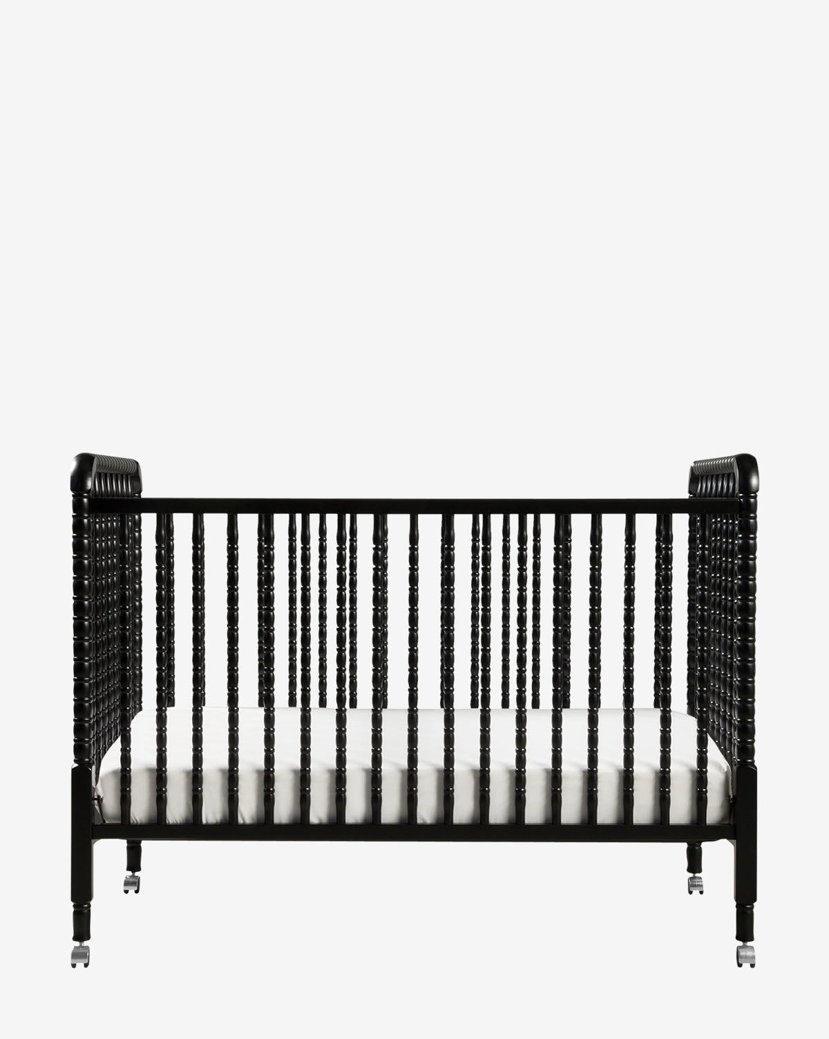 The Jenny Lind 3-in-1 Convertible Crib features a black vintage-inspired wooden frame with spindled sides, round posts, and comes with a white mattress, all set against a plain white background by McGee & Co.