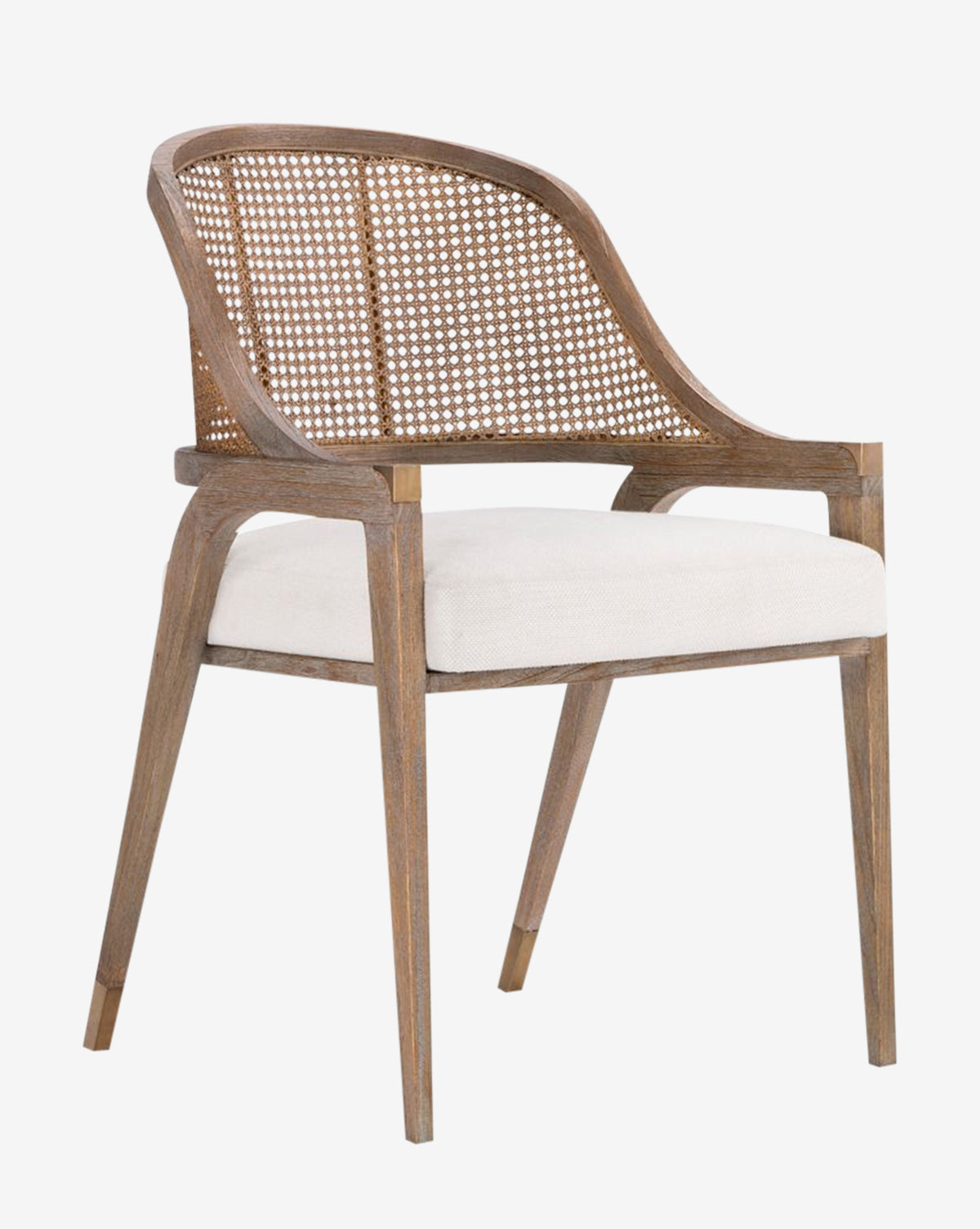 The Jensen Dining Chair combines classic and modern styles with a hand-woven cane back, armrests, a white upholstered seat cushion, and angled legs in solid Cape Lilac Mahogany, by McGee & Co.