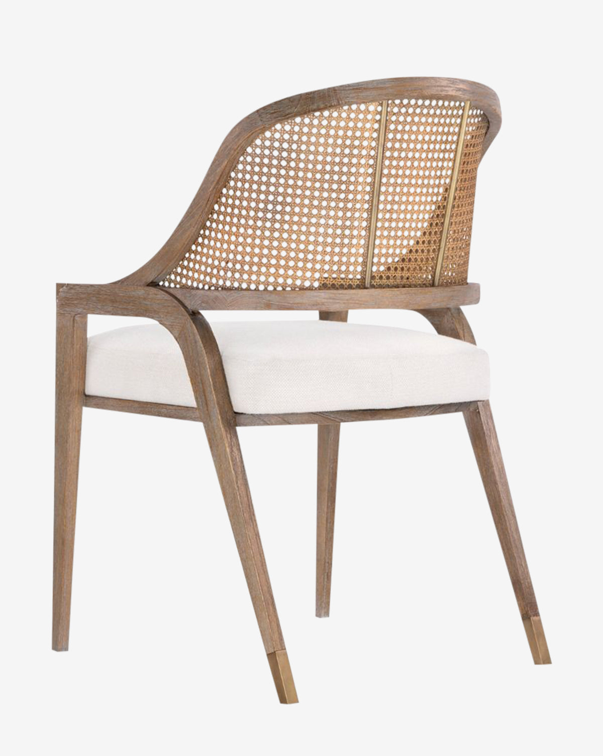 The Jensen Dining Chair, made from solid Cape Lilac Mahogany, features a hand-woven cane backrest, a light cushioned seat, and angled legs with metal-capped feet; shown from behind at an angle by McGee & Co.