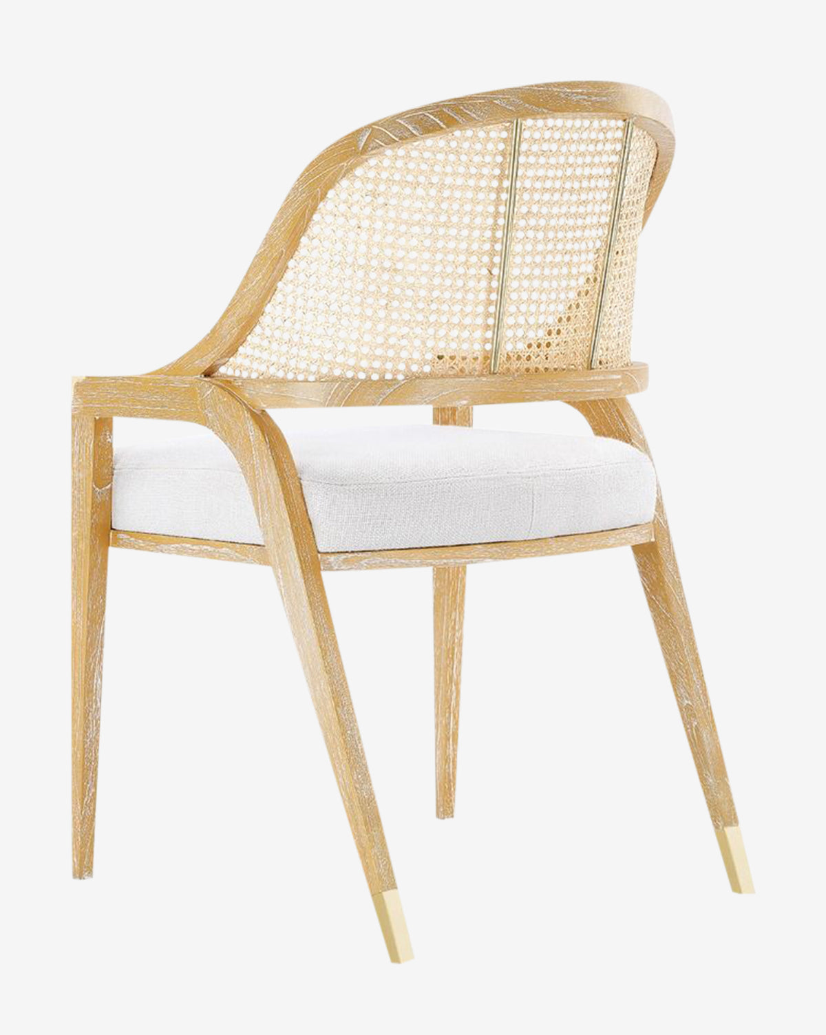The Jensen Dining Chair, crafted from solid Cape Lilac Mahogany, boasts a hand-woven cane back, curved armrests, white padded seat, and tapered legs with gold-toned metal tips for a modern and elegant look, by McGee & Co.