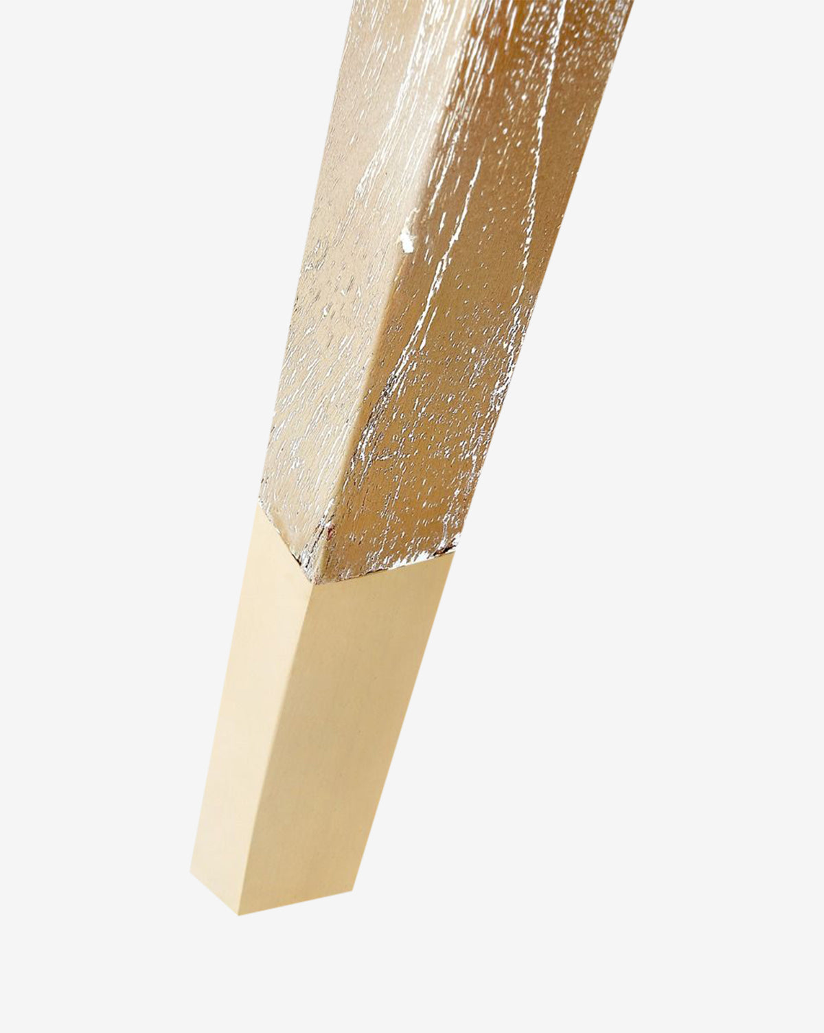 A close-up of the Jensen Dining Chair shows its wooden leg with a metallic gold finish, ending in a solid gold-colored rectangular tip, all set against a plain white background by McGee & Co.