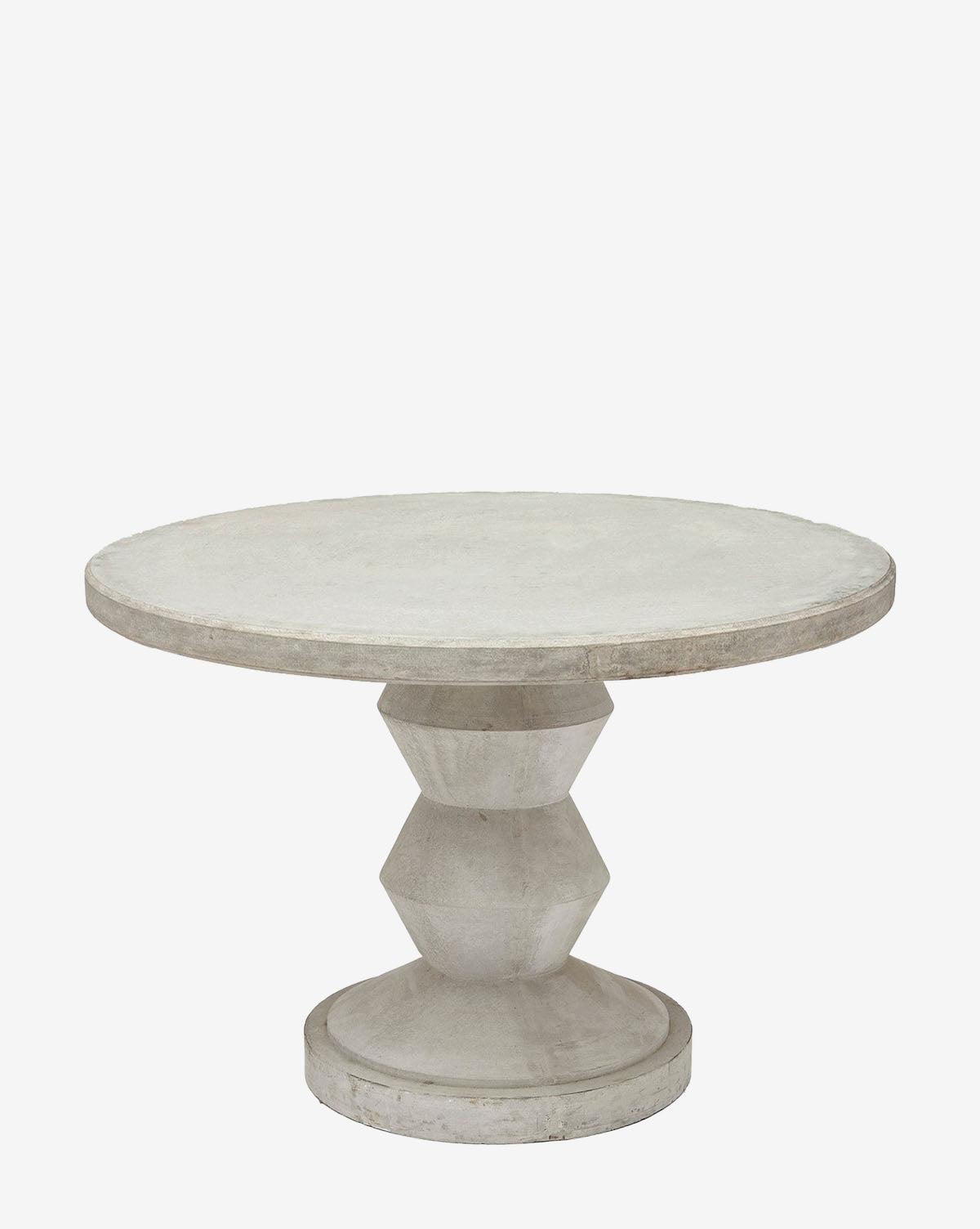 The Jessa Outdoor Dining Table is a round, light gray reconstituted stone table with a wide flat top and a geometric, faceted pedestal base—ideal for modern outdoor spaces and shown against a plain white background by McGee & Co.