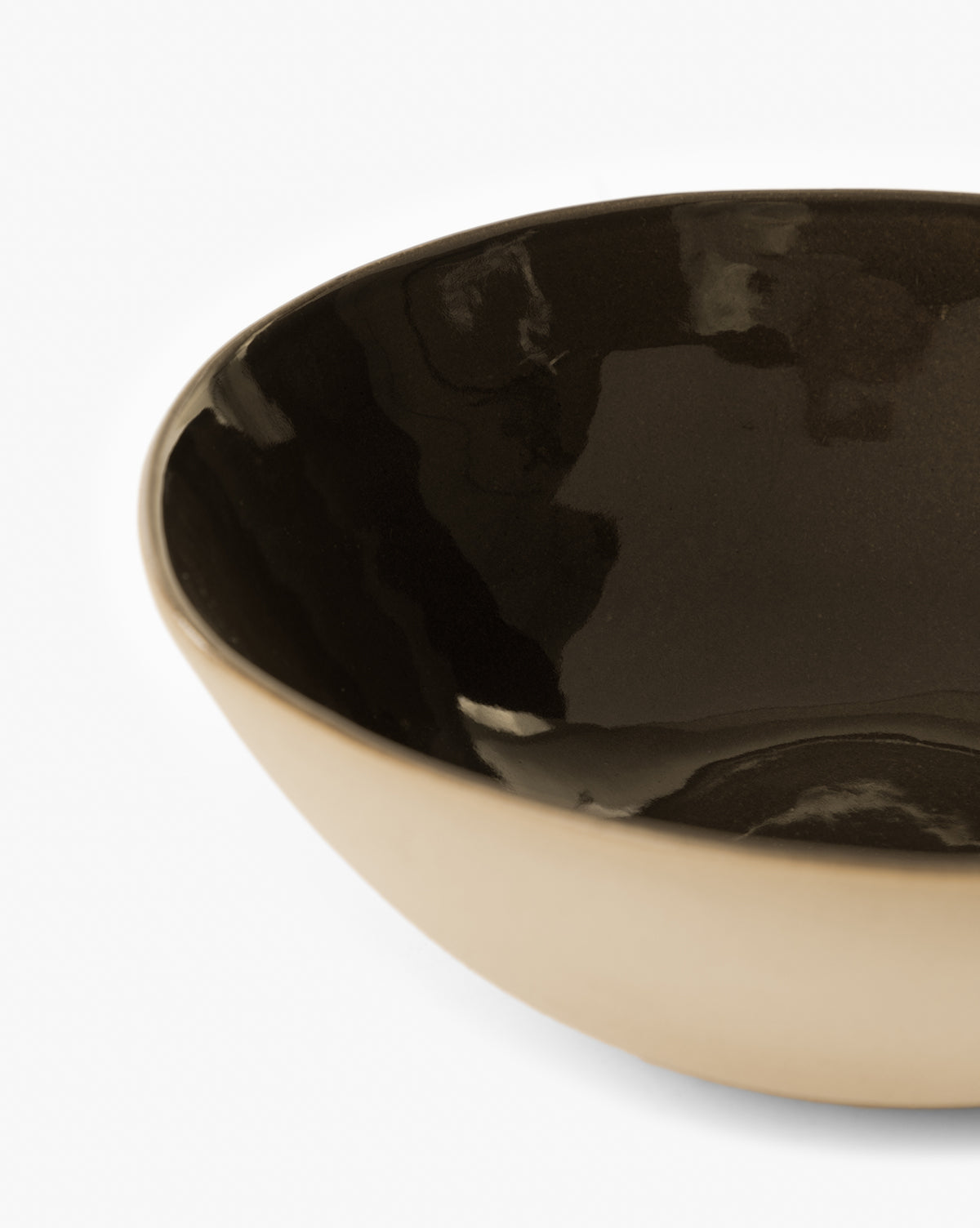 A close-up of the Joanne Serving Bowl featuring a glossy espresso glaze interior and matte light beige exterior, shown against a white background by McGee & Co.