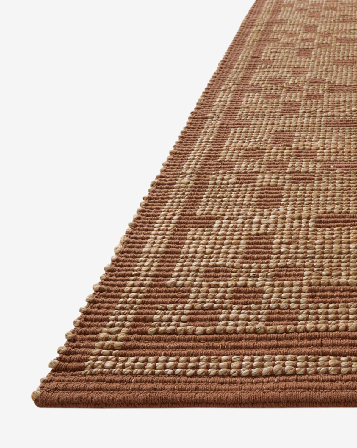 A close-up of the Judy Spice Jute Rug Collection No. 7 shows its geometric pattern in brown and beige, along with the textured surface and raised edges that highlight this handwoven neutral rug's detailed craftsmanship, by McGee & Co.