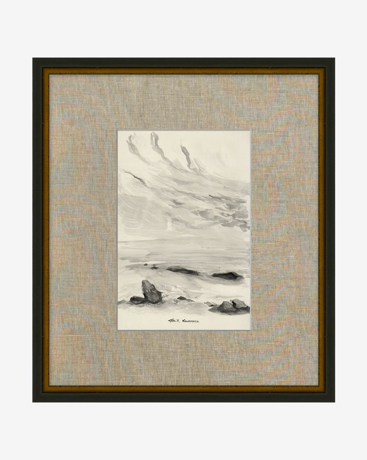 July in Kalamata: A black and white painting of a rocky shoreline beneath a cloudy sky, framed with a hand-wrapped linen mat and dark border. The artist’s signature appears below the artwork.