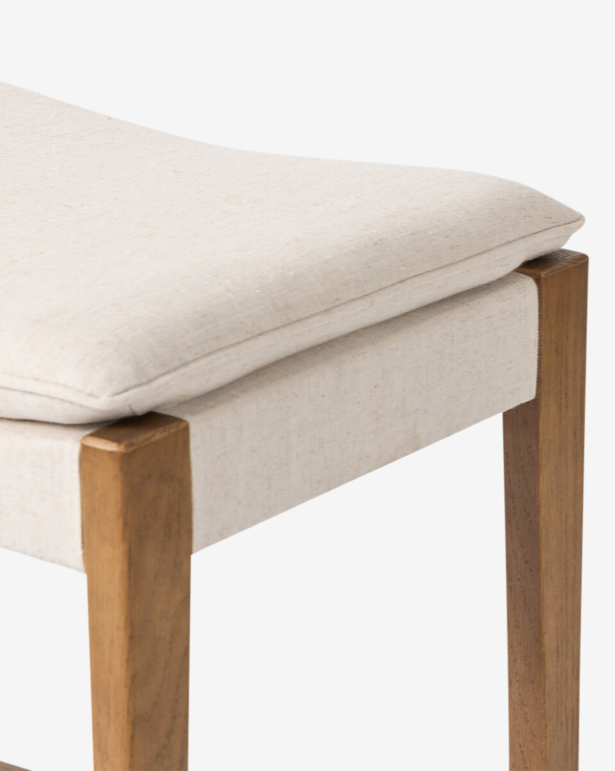The Kaelith Counter Stool by Four Hands features light beige fabric upholstery, a padded seat cushion, and a solid oak frame—ideal for complementing your kitchen countertop. McGee & Co.