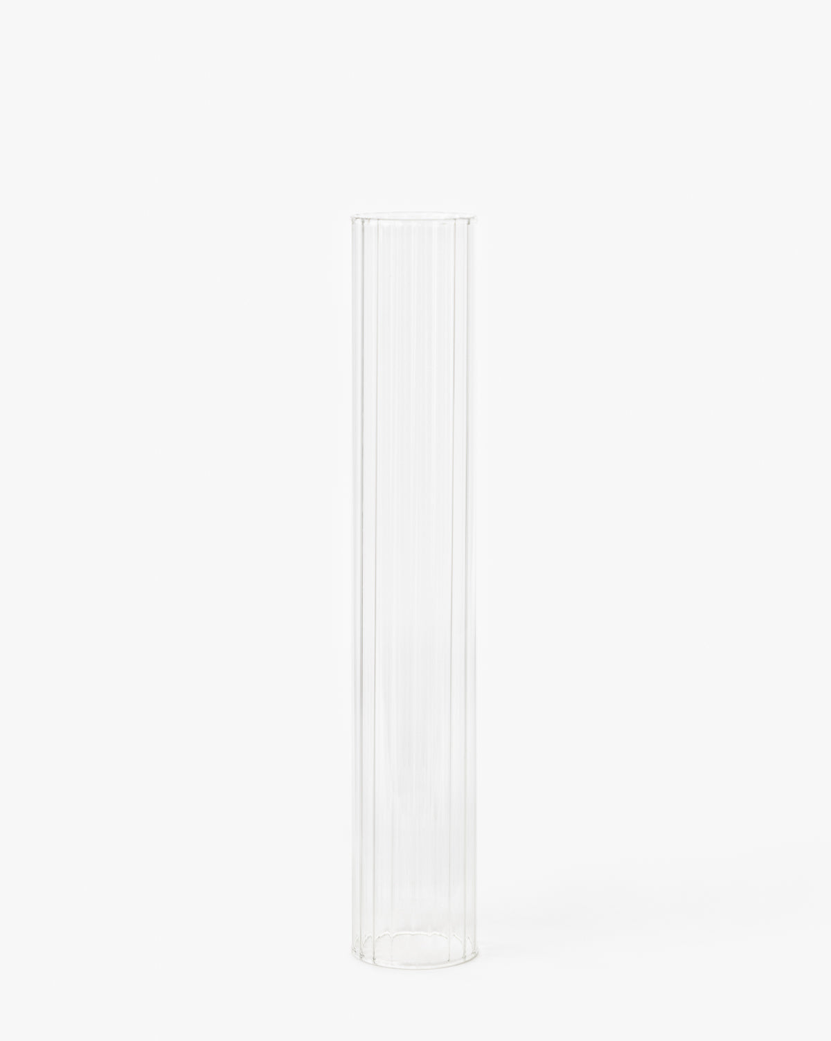 The Kalina Ribbed Candle Sleeve is a tall, clear, cylindrical glass vase with vertical ridges, resembling an elegant candle holder displayed upright against a plain white background.