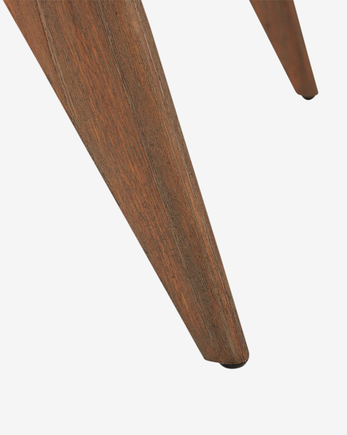 Close-up of a mahogany leg on the Kareen Stool by Villa & House, LLC, featuring a tapered, angular shape with visible wood grain and polished finish, complementing its hand-woven cane seat against a white background. McGee & Co.