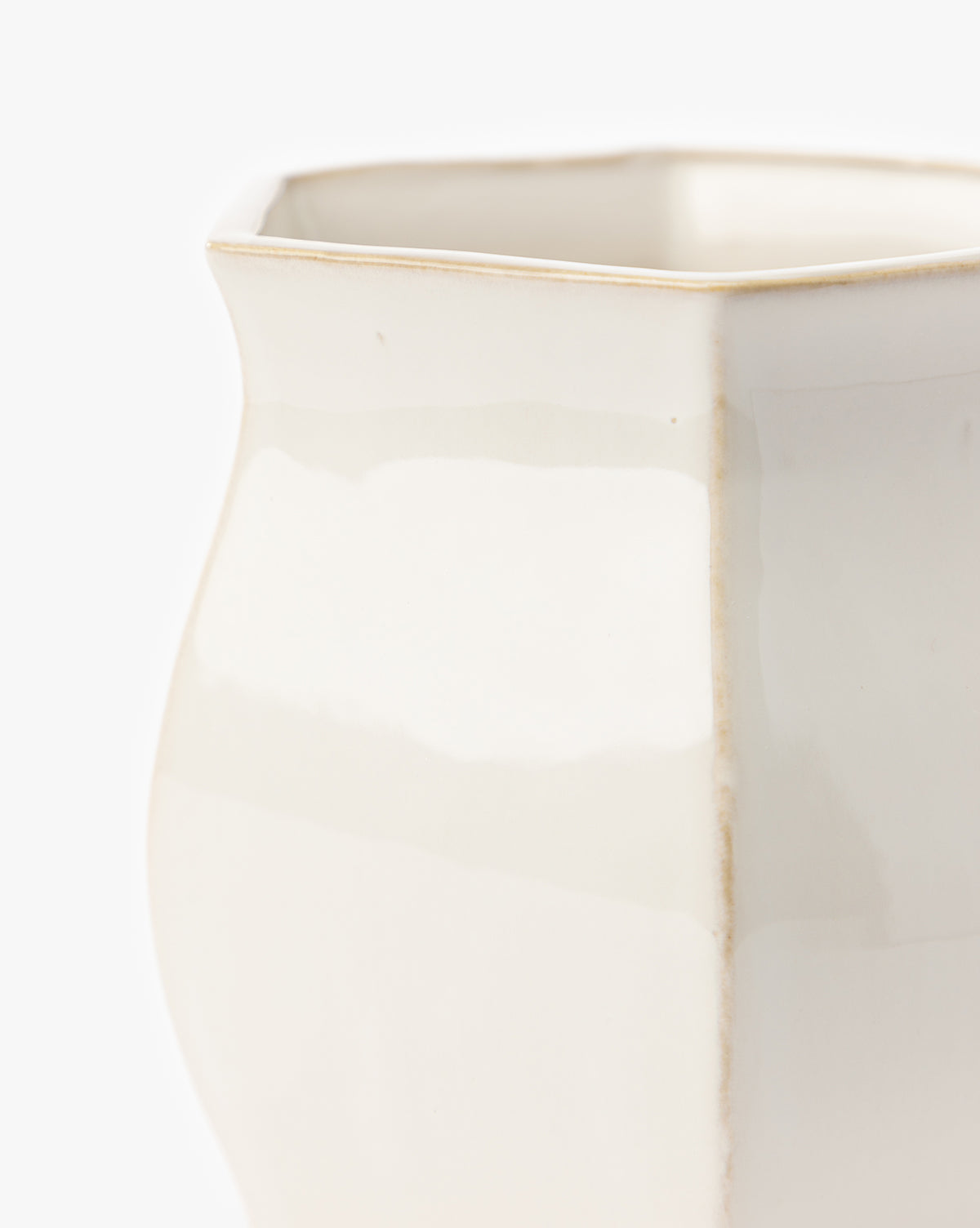 A close-up of the Kasha Cream Pot, an artisan-quality off-white ceramic vase featuring a square rim, subtle curves, and a glossy white glaze, set against a plain white background, by McGee & Co.