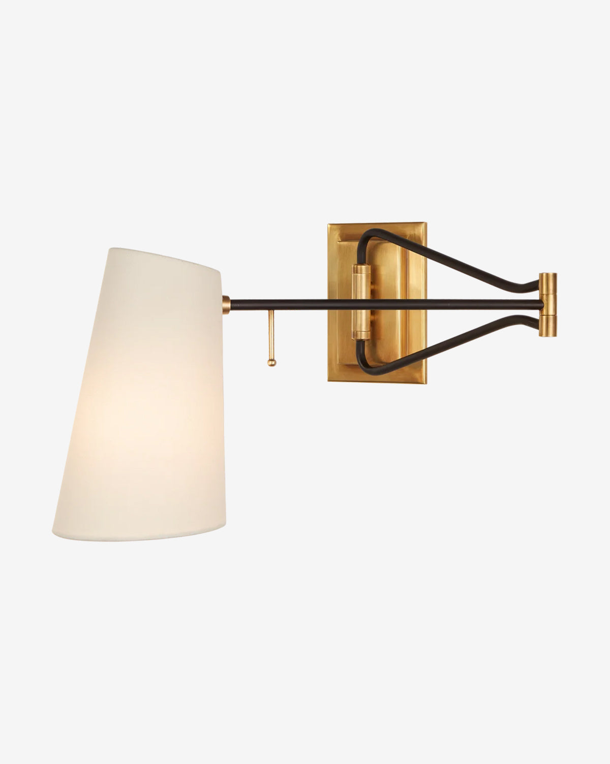 The Keil Swing Arm Wall Light by Visual Comfort & Co. Signature features an antique brass base, black metal arm, and white linen shade, illuminated against a plain light background. McGee & Co.