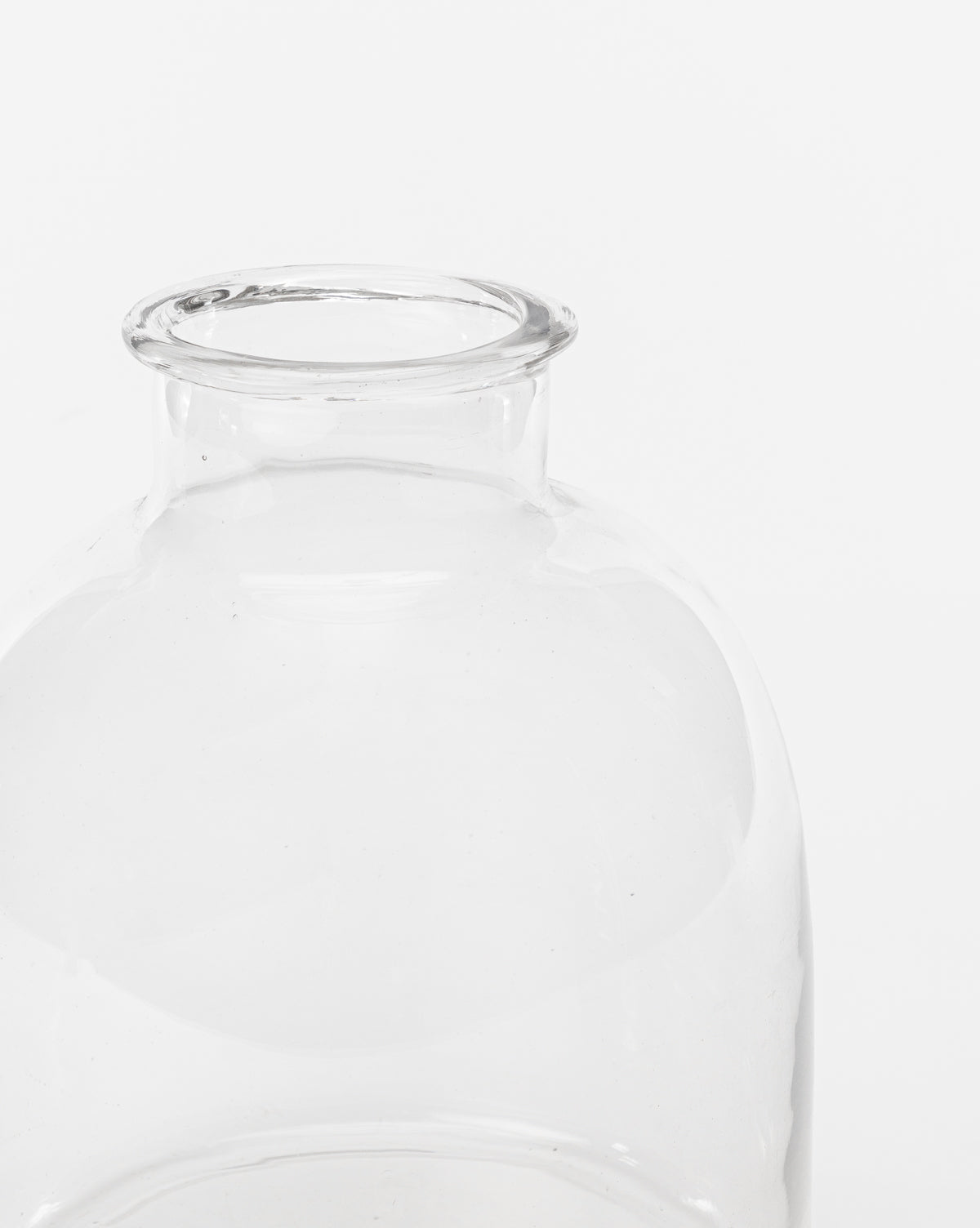 A close-up of the Kelby Glass Vase, featuring a clear, empty design with a wide neck, set against a plain white background.