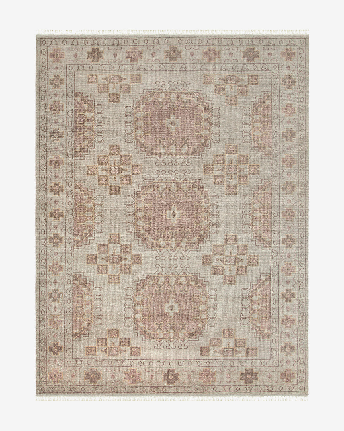 The Kenna Hand-Knotted Wool Rug showcases a rectangular design with a symmetrical geometric pattern in muted beige, brown, and blush tones, plus intricate borders and medallions for a durable yet elegant accent, by McGee & Co.