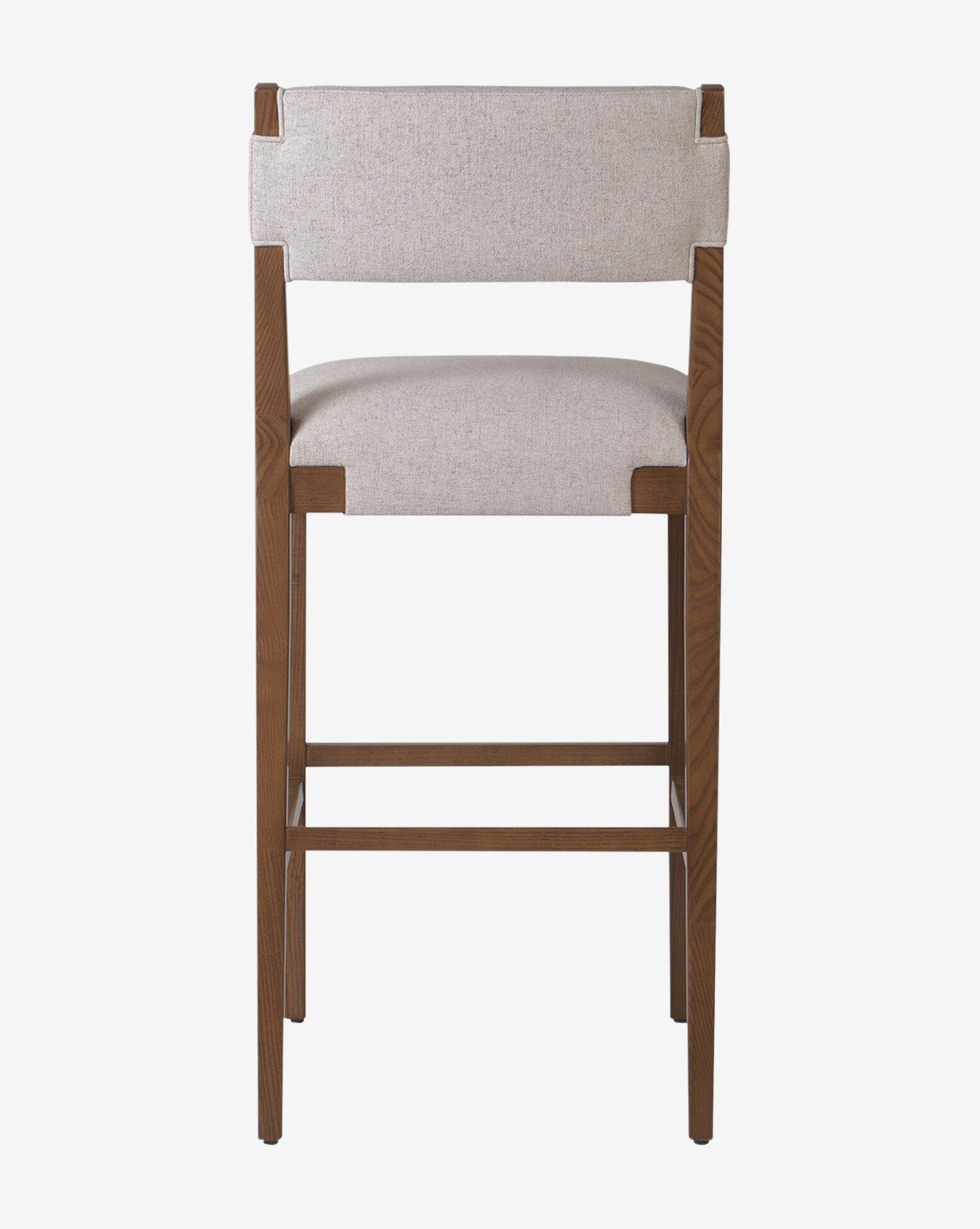 The Kennebec Stool by Four Hands features a tall ash frame with a light beige performance fabric seat and backrest, shown from the back against a plain white background—ideal as a stylish kitchen stool. McGee & Co.