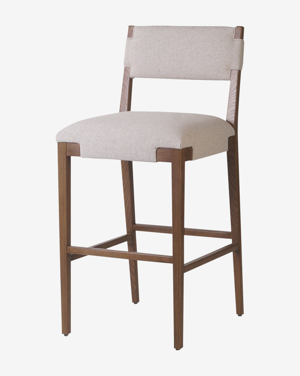 The Kennebec Stool by Four Hands features a light beige performance fabric seat and backrest, medium brown ash frame, and footrest bar for modern kitchen seating. McGee & Co.
