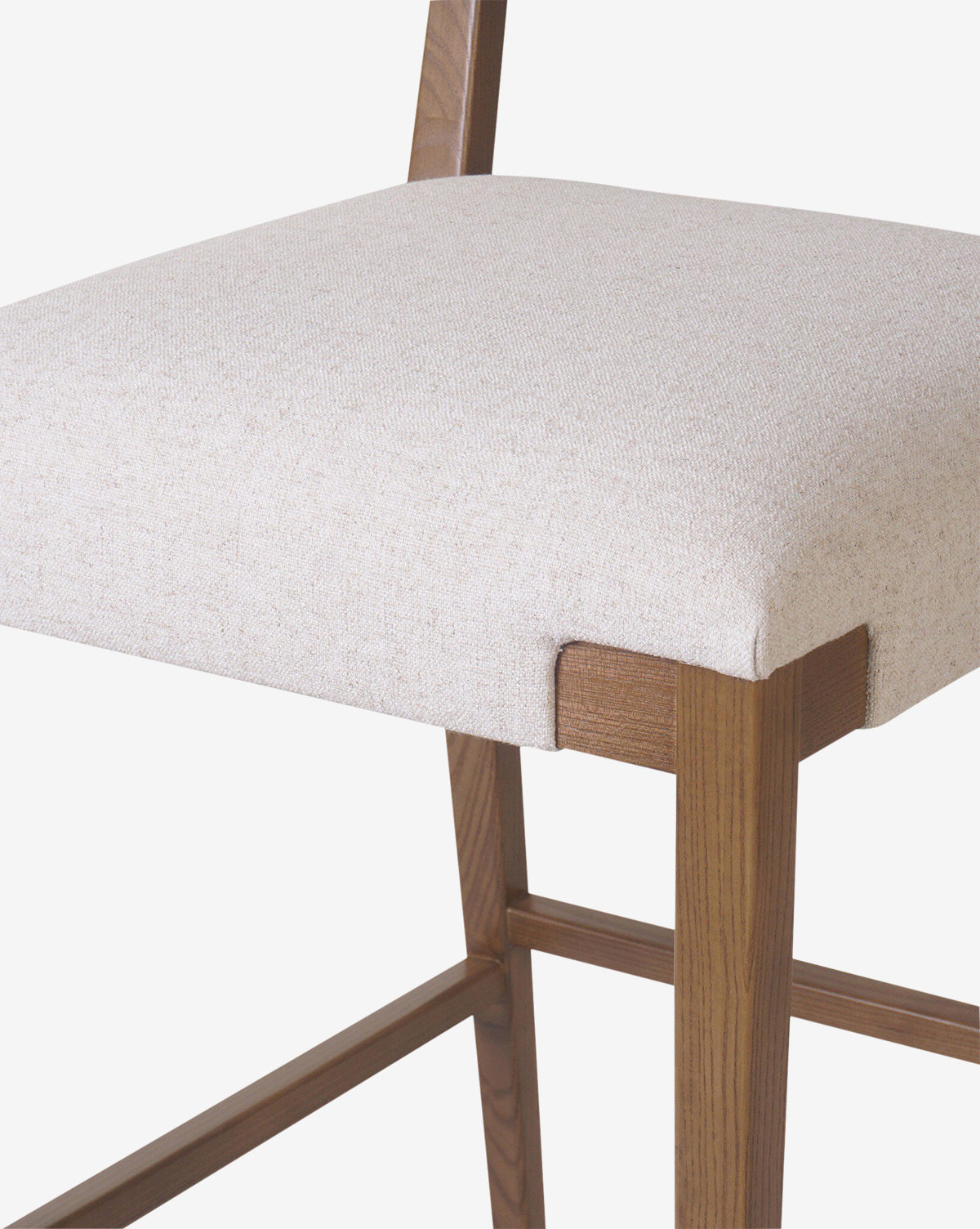 The Kennebec Stool by Four Hands features a modern ash frame with a natural finish, light beige performance fabric seat, clean lines, and visible joinery—showcasing minimalist design in any kitchen setting. McGee & Co.