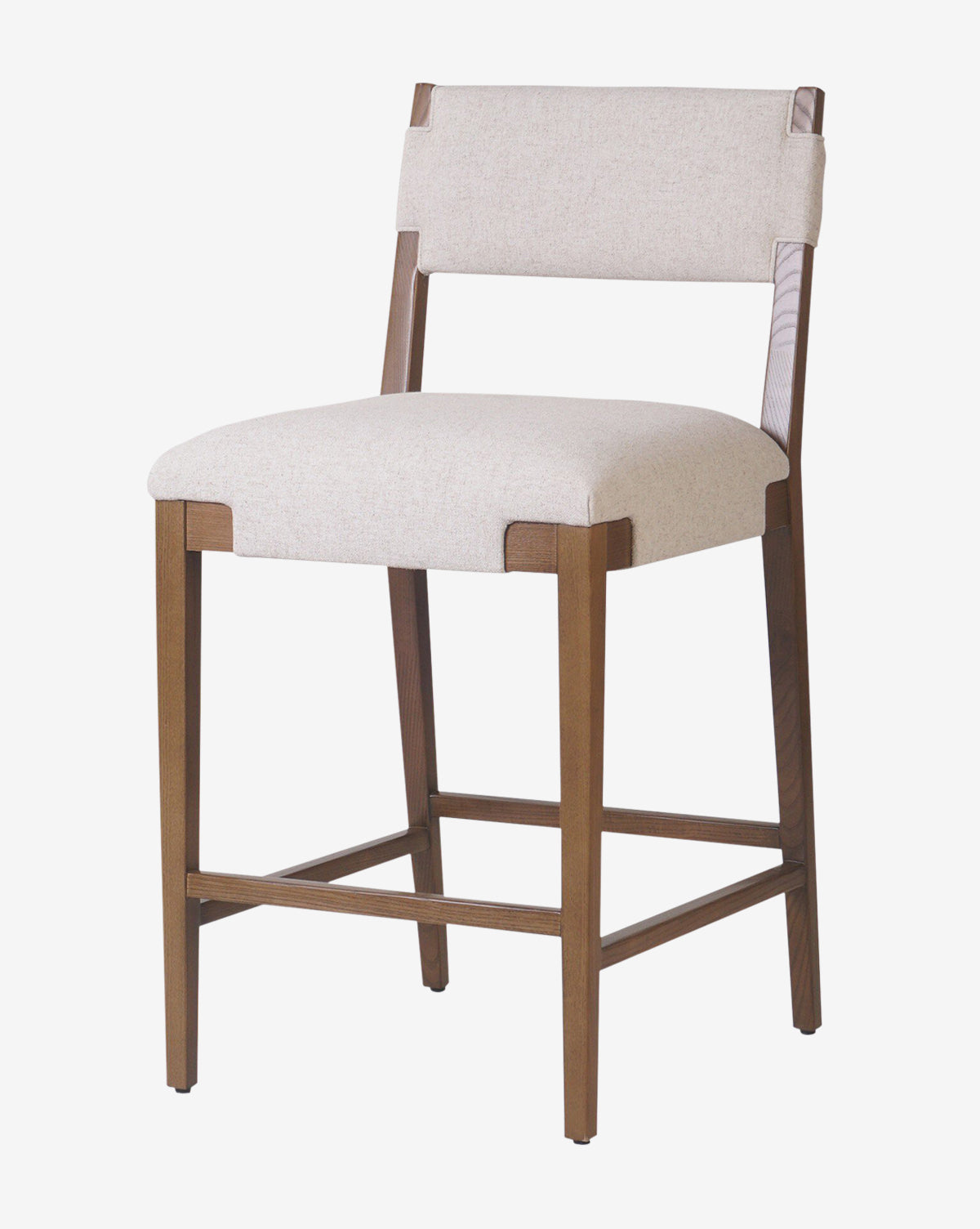 The Kennebec Stool by Four Hands features a modern design with clean lines, a medium brown wood frame, low back, footrest, and a light beige performance fabric upholstered seat and backrest by McGee & Co.